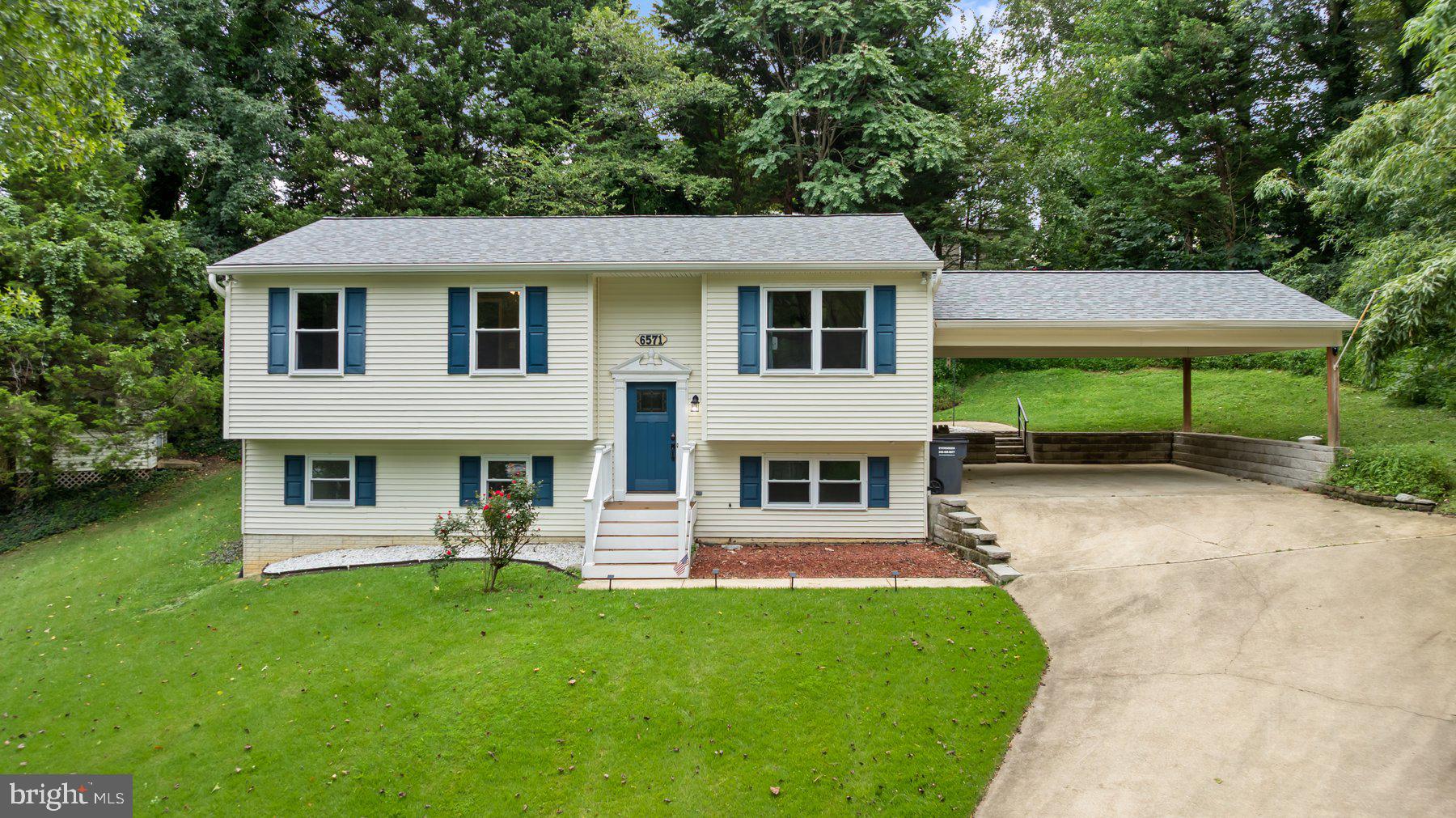 Move-in ready 3BR/2.5BA expanded split foyer with two-car carport, offering privacy, extra living space, and a serene setting at the very end of a quiet one-way-in/one-way-out street in Summer City. Enjoy the peace of being the last home on the block with minimal traffic and forest-like surroundings. Step inside to find natural light, a soft neutral palette, ceiling fans, and spacious rooms throughout. The main level features a large living room, a well-appointed kitchen, and a beautiful family room with a vaulted beadboard ceiling and gleaming hardwood floors. The kitchen offers abundant cabinet and counter space, tile backsplash, pantry closet, newer appliances, double sink, butcher block island with seating, and room for a breakfast table. Down the hall are two secondary bedrooms, a full bath, and a primary suite with double closets and a private bath. The finished lower level expands your living space with a large den highlighted by a corner stacked-stone gas fireplace, plus laundry, half bath, additional storage, and sliding doors to the side yard. Outdoor living is just as inviting—step from the family room onto a wood deck overlooking the backyard with green space, a storage shed, and mature trees. This home is truly move-in ready and offers the perfect blend of comfort, privacy, and convenience, all just minutes from shopping, dining, and major commuter routes.