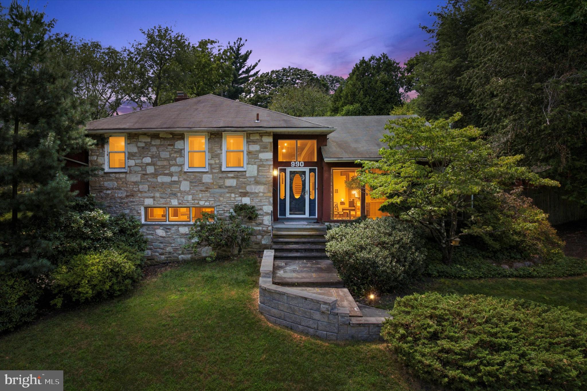Welcome to 990 Indian Creek Road, a beautifully maintained stone-front split-level home in Jenkintown Manor offering more than 3,000 square feet of living space with 4 bedrooms and 2.5 baths. The open floor plan is ideal for entertaining, featuring a sun-filled living room with cathedral ceilings and large windows, a spacious kitchen with abundant cabinetry and an oversized island, a formal dining room, and a family room with a stone-front gas fireplace. The primary suite includes a tile bath with walk-in shower and a large walk-in closet with laundry. The finished lower level provides flexible living and storage space. Outdoor amenities include a sparkling saltwater pool, relaxing hot tub, Trex deck, outdoor dining and grilling area, a pool cabana with a convenient half bath and changing room, and a greenhouse. This rare offering in the award-winning Abington School District is just minutes from shops, dining, and major roadways.