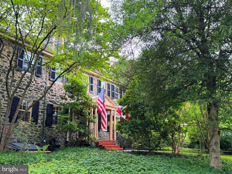 Step into Baltimore history at 2436 Pickwick Road—an exquisite 1840s stone residence nestled in the heart of the nationally recognized Dickeyville Historic District. GORGEOUS! Thoughtfully restored and masterfully maintained, this 5-bedroom home blends timeless craftsmanship and finishes with modern comfort and ample storage throughout. From its original mill village roots, Dickeyville has evolved into one of Baltimore’s most cherished enclaves—tucked alongside the Gwynns Falls, rich in community spirit, and defined by cobblestone paths, gas lamps, and preserved architecture. This residence sits proudly on a private knoll, offering a center-hall layout, expansive reception rooms, renovated kitchen plus butler’s kitchen, and five generous bedrooms. Outside, enjoy lush gardens, mature landscaping, and a rare two-car stone garage—all moments from trails, parks, and the Gwynns Falls. Historic character, refined living, and a sense of place that’s truly one of one.