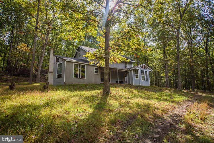 Huge Price Reduction!! so bring the whole family and enjoy the West Virginia mountains and Cacapon River. Spacious layout with an open floor plan, 3 wood stoves and a beautiful fireplace. Sitting room, loft, 3 bedrooms, high ceilings, wood floors, outdoor patio. Easy accessibility right off the county lane. Enjoy the river through the day and a camp fire in the evenings, what could be better.