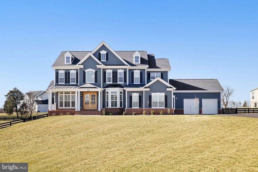 Welcome to 12446 Barrel Oak Lane — a luxurious retreat on 1.81 acres of flat, open land in charming Lovettsville, VA with over $100,000 in post sale upgrades. 

This exquisite Carrington Homes build, featuring the Huntwick Place floorplan, offers 6,315 square feet of beautifully finished living space designed for gathering, relaxing, and celebrating life’s moments.

Step through Carrington’s signature double front doors into a main level filled with warmth and elegance. The gourmet farmhouse kitchen boasts custom cabinetry, stainless steel appliances, an oversized island, and a walk-in pantry — perfect for cooking, entertaining, and everyday living. The butler’s pantry, with arabesque backsplash, floating shelves, and refrigerator drawers, makes hosting effortless.

The sunlit living room with wood beams and a gas fireplace creates a cozy atmosphere, and you’ll love having two separate main-level offices — ideal for work-from-home ease or creative spaces. A formal dining room and an additional sitting room (easily convertible to a main-level bedroom) offer flexible, welcoming spaces. Luxury vinyl plank flooring ties the design together, and the oversized four-car garage — finished with epoxy floors and painted walls — is as polished as it is practical.

Upstairs, the primary suite is your personal haven, featuring a spa-like bath with soaking tub, frameless glass shower, separate his-and-her vanities, and dual oversized closets. Three additional bedrooms, including one with an en-suite bath and a shared Jack and Jill bath, complete this inviting second level.

The walk-out lower level is an entertainer’s dream, with a spacious family room, custom wet bar (beverage fridge + sink), and a private fifth bedroom with en-suite bath — perfect for guests or in-laws. You’ll also find a dedicated gym or movie theatre room on this level, offering even more ways to relax and recharge at home.

Step outside to enjoy your composite deck overlooking wide-open green space — perfect for morning coffee, evening gatherings, or soaking in those peaceful Loudoun County sunsets.

Additional features include a whole-home water filtration and softener system, well and septic utilities, and 1.81 acres of serene, flat land to enjoy.

Plus, you’re just minutes from local favorites like Market Table Bistro, The Restaurant at Patowmack Farm, Train to Mumbai, Andy’s, and the Lovettsville Co-Op — where community and connection are always close by.

12446 Barrel Oak Lane is more than a home — it’s your personal haven, gathering place, and next chapter waiting to unfold. Come explore all that’s possible.