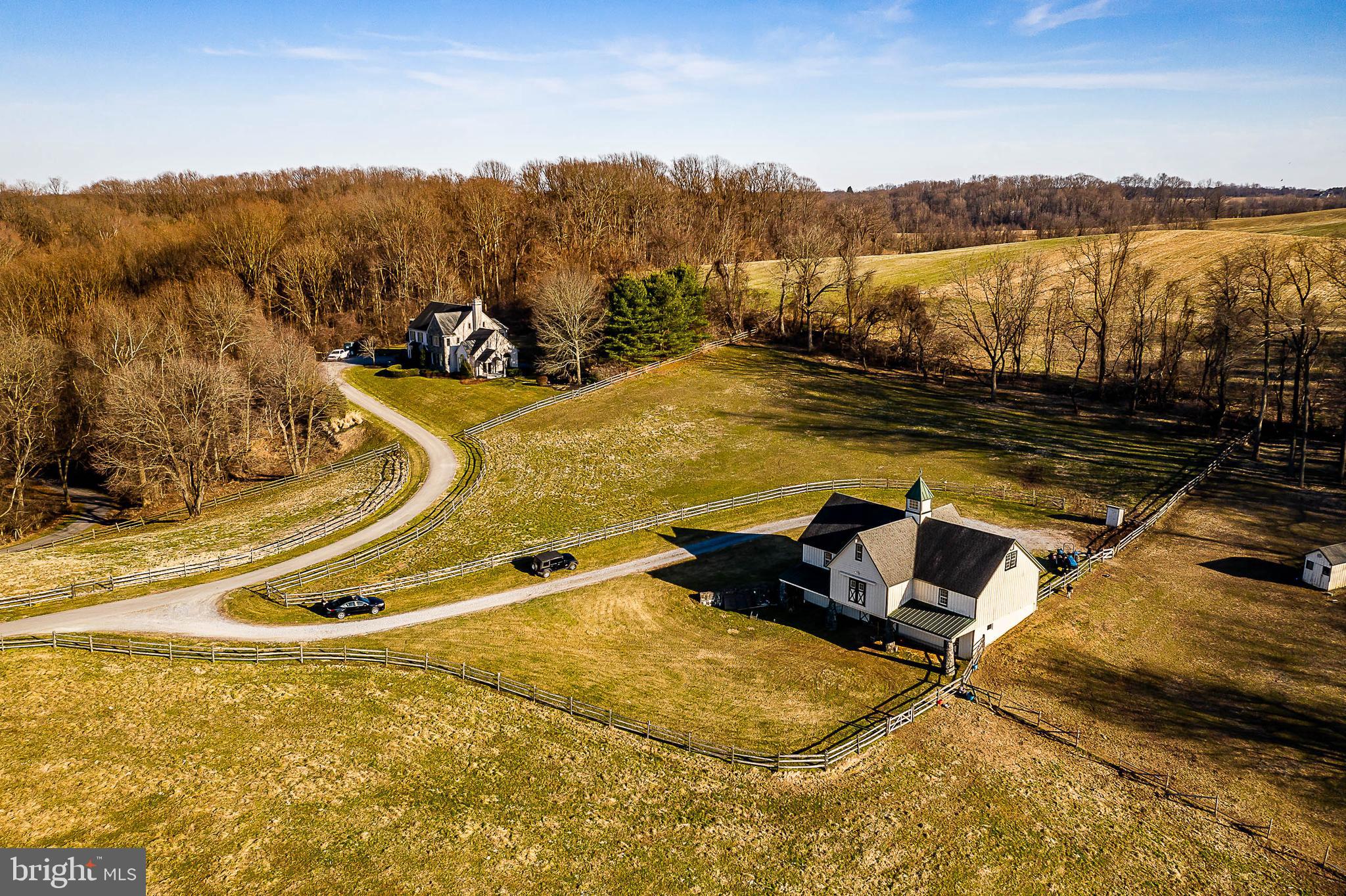 Unique and rare opportunity to own a one-of-a-kind custom-built home with breath-taking panoramic views of Chester County! Situated on top of 30+ acres and adjoining the Cheslen Preserve, this property has it all. The main floor opens into the foyer with cathedral ceilings, plenty of natural light, and hardwood floors that lead into both the dining and living room. The entire home feels elegant and warm. From the gourmet kitchen, which includes a spacious breakfast nook and sitting area, to the large family room accented by the skylights and floor-to-ceiling, double-sided stone fireplace! French Doors lead you from the family room to the covered porch and flagstone patio where you can enjoy the remarkable views of the countryside's famed open space and the property's own small pond and waterfall. Upstairs, there are 4 bedrooms and 3 full baths. The large master bedroom includes a sitting area, walk-in closets, a gas fireplace, and an updated master bath with both a standing shower and soaking tub. There is a princess suite with its own ensuite bathroom and the additional two bedrooms have a Jack-and-Jill bath. There is a 3-car attached garage with access to the mudroom and half bath. Just down the hill is the barn with 4 stalls, a tack room, and a wash stall with brick flooring. The upper barn offers an abundance of storage. The property offers plenty of pasture for turnout and miles of trails for riding!