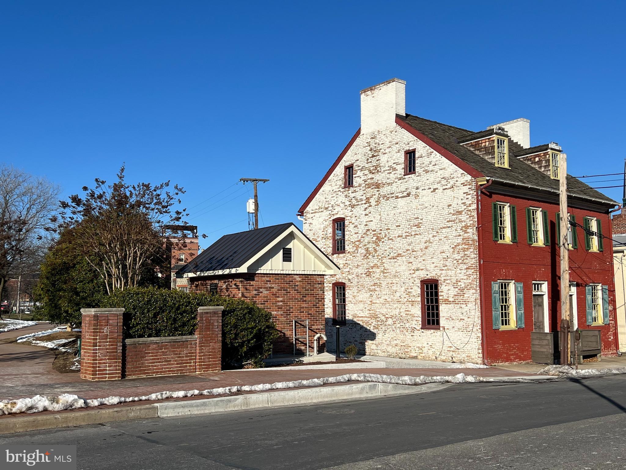 Nestled in the heart of a vibrant, ever-evolving city, this historic 1860 brick shell stands as a testament to the industrial elegance of a bygone era. Stripped down to its essential character, the building offers soaring ceilings, exposed original brickwork, and many rehabbed windows that flood the interior with natural light. The roof is replaced with a brand new metal roof on one section and wood shingles on the main portion of the buildling
The façade retains its aged charm—textured red brick —perfect for maintaining an authentic aesthetic while adapting to contemporary use. With no interior walls or floors remaining, the open shell provides unmatched flexibility: build up or in, divide vertically or horizontally, or leave sections open for outdoor terraces or green spaces.
Use Possibilities:
Restaurant: Ideal for a dramatic, indoor-outdoor dining experience. The raw brick walls offer instant ambiance. Outisde open-air seating is possible.
Retail: A boutique or gallery could thrive here, drawing in foot traffic with the visual intrigue of the historic shell situated along Carroll Creek..
Residential: The shell invites innovative loft-style living— condos - single or multi family
With the soul of the 19th century and the bones to support a modern vision, this building has endless potential