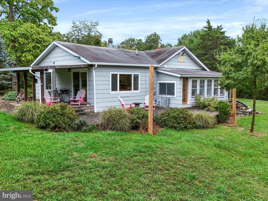 Here is a rare find in Western Maryland-- Move-in ready home plus 36 Acres of land! Property borders Warrior Mtn Wildlife Management Area.  Icing on the cake--Brand new 30x40 pole barn with unlimited uses!
Single level home with modern farmhouse style and many recent upgrades by current owners. Spacious & inviting great room has loads of natural light, big picture windows, vaulted ceiling, newer carpet and cozy wood burning fireplace.  Sliding doors lead to a covered patio. Totally remodeled bathroom with stackable W&D.   Nicely equipped kitchen and heated sunroom- perfect spot to sip coffee looking out the wall of windows to woods and wildlife year-round.  Plenty of outdoor living & entertaining space on the paver patios.  Check out the new pole barn! With electric and water, this 1200 SQFT beauty makes a great workshop--dream garage--or multi-stall horse barn.  Three 10x12  doors and high ceiling space-tall enough to park the largest RV or farm equipment. Also included- New storage shed with electric. Hiking/biking/ATV trails run through the woods and deer are plentiful. Taxes are LOW due to forest management plan in place. Rocky Gap State Park and resort is nearby, Full list of property improvements on file. This tranquil setting can be your perfect homestead or simply your oasis away from city life, less than 2 hours from Baltimore/Washington. Take a look and make it yours!