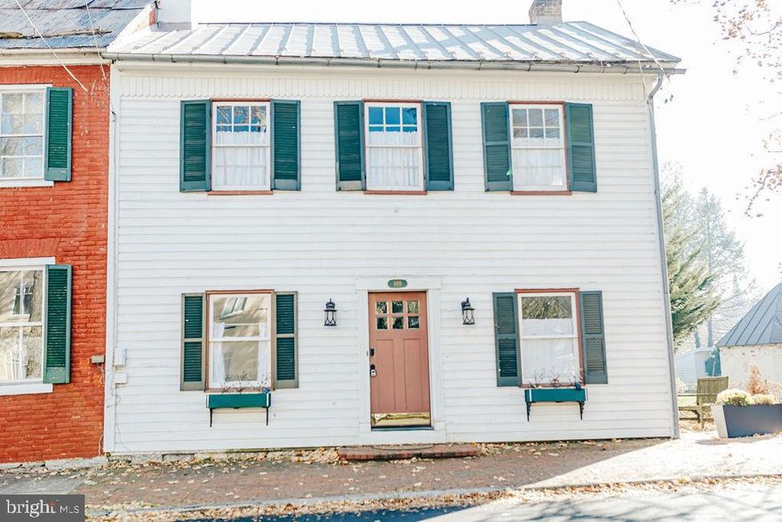 BRING AN OFFER:  Now is your chance to live in historic, walkable, Shepherdstown, WV.  This historic home built in 1799 is located in the center of town.  Just one block to German Street and one block to Shepherd University.   Inside this home, the historic charm remains with beautiful archways, some original windows, and wood floors throughout.   The first floor includes an open living room and TV area with built in shelving and storage.  The modern kitchen includes electric range, dishwasher, refrigerator and center island.  At the back of the house a small dining room looks out onto the back patio and garden. The first floor includes a laundry/mudroom with newer washer, dryer, and second refrigerator.  There is a full bathroom with deep tub and shower.  Upstairs the first two bedrooms are roomy and bright.  A full bathroom with claw foot tub separates the front and back wings of the home.  The back two bedrooms are connected by a sunroom that looks out over the back yard gardens. Enjoy your morning coffee or a good book in this warm and sunny space!  Shepherdstown has many family and pet friendly events and activities all year round.   This is your opportunity to live in this historic, walkable town!