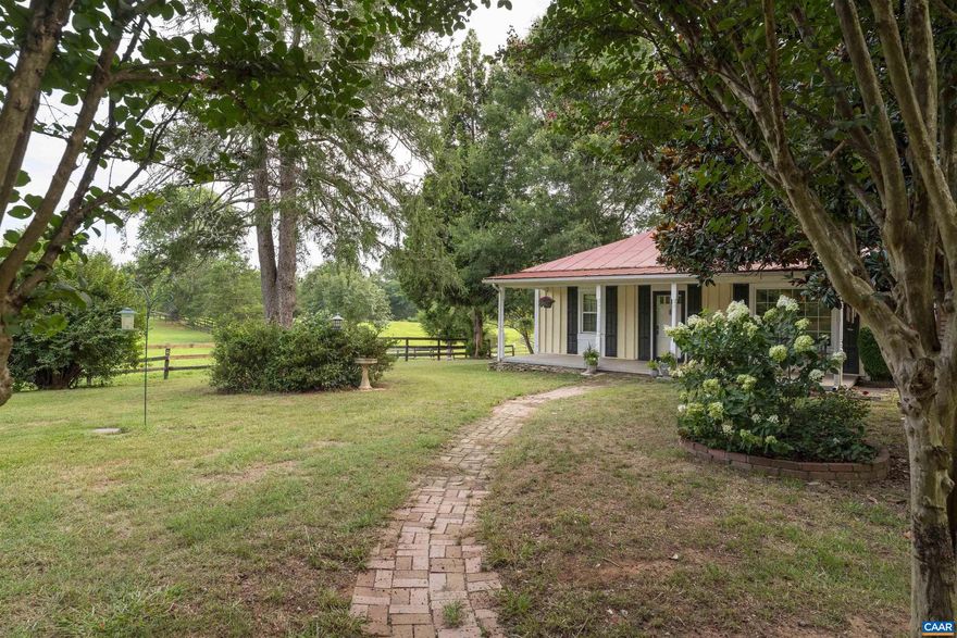 Just south of Gordonsville, this 15-acre horse property offers a rare mix of comfort, function, and open space. A private drive leads to a 2-bedroom, 1.5-bath 1940s cottage with nearly 1,900 SF of living area, featuring hardwood floors, a fireplace, a sunlit family room, and a practical mudroom. A heat pump provides year-round comfort, and the home rests on a solid block foundation with a metal roof. The land is open and usable, with fenced pasture, mature trees for shade, and well-planned infrastructure for horses or small farm use. The main barn measures 220? x 54? and includes thirteen 12' x 12' stalls, each with rubber mats, automatic waterers, and electric outlets. A 54?-diameter indoor round pen and a 90? x 250? outdoor ring with river sand and sawdust footing offer ideal riding conditions. Five paddocks, three with run-ins, each have their own hydrant. The barn also features two hot water heaters and a bathroom. Zoned A-2, no HOA. Well and septic in place. Located off Route 15, less than 5 minutes to historic Gordonsville and about 30 minutes to Charlottesville. A well-equipped, manageable farm - ideal for training, boarding, or simply enjoying country life with purpose-built amenities already in place.,Fireplace in Living Room