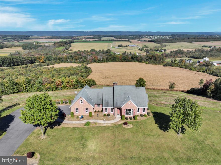 Welcome to your dream home! This stunning all-brick residence is more than just a house; it's a haven perched to provide a 360-degree scenic view for miles, ensuring a tranquil and picturesque escape for its fortunate new owners.  Sitting on just over 2 acres, this elegant home not only boasts a million-dollar view but is also meticulously engineered for expansion and convenience. This home features 3 1st floor bedrooms with ceiling fans for comfort. The 1st floor master suite provides incredible views and has a full en suite bath. There is even an office on the first floor for those with the shortest commute! You'll love entertaining  guests in the spacious living room, complete with vaulted ceilings and a gorgeous gas fireplace.  The sunroom is sure to be a favorite spot to relax and as you take in the breathtaking views while you enjoy your morning coffee. The potential for growth is immense, with provisions for adding two extra rooms on the second floor and additional rooms in the expansive walkout basement. Pre-plumbing for two additional bathrooms, one on the second floor and another in the basement, offers flexibility for future enhancements. Practicality meets luxury with 990 gallons of oil capacity, allowing you to manage costs efficiently and go up to a year without oil deliveries. The 400-amp underground service ensures a robust electrical infrastructure, while the compressed air plumbing and wash station, complete with floor drains, in the main garages add a touch of convenience. The home is thoughtfully equipped with a lower utility garage featuring a floor drain, central vacuum ports in all garages and the walkout basement, and a three-flue brick chimney catering to the heating system, gas log in the living room, and one for future use in the basement. Efficiency is key with a four-zone controller for the heating system, complete with two open zones, a gas line running the entire length of the house, and conduit chases in most rooms for seamless cable and internet wiring. For added convenience, the property comes with a washer, gas dryer, and refrigerator in as-is condition. The extra tall/high walkout basement adds an extra layer of appeal, making this residence a must-see for qualified buyers seeking a one-of-a-kind home with panoramic views and unparalleled solitude.  No interior photos at this time for owners privacy.  Don't miss the opportunity to make this extraordinary property your own!