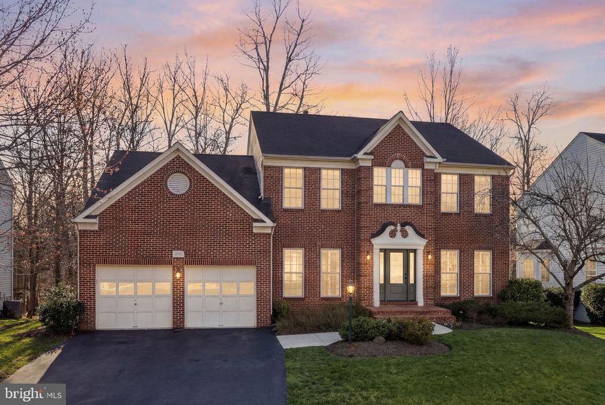 Experience refined living in this exceptional single-family residence nestled in the highly sought-after Lake Manassas community, where breathtaking views take center stage. Perfectly positioned to back directly to the woods, this four-bedroom, three full and one half bath home offers a rare blend of elegance, comfort, and natural beauty.

From the moment you arrive, the meticulously manicured yard sets the tone, showcasing a stunning collection of mature landscaping including dogwoods, redbuds, crepe myrtles, and more—creating a picturesque setting year-round. Step outside to your maintenance-free deck (installed in 2019), the ideal space for entertaining or simply unwinding by your custom stone fireplace.

Inside, the home has been thoughtfully updated with modern finishes and high-quality improvements. Brand new hardwood flooring flows seamlessly throughout the main level, stairs, and upper landing, enhancing both style and durability. The heart of the home features a new wall oven and built-in microwave (2021), perfect for culinary enthusiasts.

Upstairs, retreat to the luxurious primary suite, complete with new carpeting (2021) and a fully renovated spa-inspired bathroom (2021), offering a private oasis of relaxation. Additional updates include a new HVAC system (2020) and hot water heater (2020), as well as a new roof (2017), ensuring peace of mind for years to come.

For outdoor living, enjoy the convenience of a direct gas line to the grill, making hosting effortless.
This is more than a home—it's a lifestyle defined by stunning views, thoughtful upgrades, and an unbeatable location. Don't miss the opportunity to make this retreat your own.