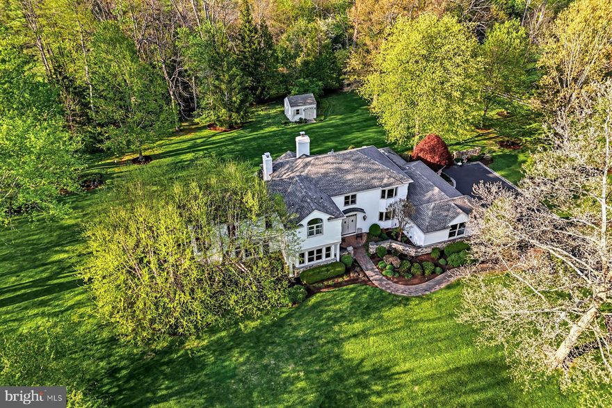 Welcome to this sun-filled, beautifully renovated residence set within the highly coveted Leopard Lakes community with  access to 11 acres of space surrounding a lake and private beach, offering swimming, kayaking, tennis or pickleball courts, a recently installed playground and private views from the walking path bordering the lake. Seize this  rare opportunity to enjoy this exceptional home offering both lake and creek views in a breathtaking setting. The current owners have spared no expense in transforming, expanding and upgrading this home with a bright open floor plan set on 1.5+ spectacular acres with specimen plantings and serene views at every turn. Exterior features include a stone-walled front courtyard, Belgian block-lined driveway, brick paths, private deck, sprinkler system, freshly painted exterior and full house generator.  The welcoming double doors with beveled glass open into a spacious entry foyer with open views of the sun-filled living and dining rooms, perfectly refinished and new light oak floors throughout the entire house, breakfast room  and  access to the other first floor living spaces including a  spacious office with built-ins and fireplace, fabulous new expanded gourmet kitchen with white custom Century cabinets with pull-outs, quartzite countertops, a service bar area, Thermador gas range with steam and convection ovens, bright breakfast room, adjacent family room with vaulted, beamed ceiling, wood burning fireplace and access to the rear deck and grounds, inviting sun room with vaulted ceiling, beam detail and access to the rear deck and backyard, a mud room/laundry room with plenty of closet and storage space and a beautifully renovated powder room.  Two staircases leas you up to the spacious second level which features an incredible primary suite owners’ magnificent retreat featuring a large bedroom with tray ceiling, cedar-lined window seat overlooking the back yard, elegant marble bathroom with dual vanities, spacious shower, soaking tub and private water closet,  dual walk-in closets with pocket doors, outfitted by California Closets, two additional bedrooms that share a renovated hall bathroom and a fourth bedroom with a walk-in closet and renovated ensuite bathroom. The lower level has also been partially finished by the current owners and offers a playroom/ gym space, a fully conditioned wine room and lots of storage. Additional features include freshly painted neutral decor,  modern architectural designs, custom moldings, newer Marvin windows, custom lighting and a whole house generator. Welcome home but feel like you're on vacation every day with the view of the lake,  while hiking on the trails and listening to the babble of the flowing water, relaxing on the beach or taking your kids or grandkids to the new playground.  The lake and grounds are owned by Leopard Lakes Farm, Inc. Buyers pay this corporation a one-time transfer fee of $10,000 at settlement and annual dues of $2,659 per household. Just minutes from renowned public and private schools, endless recreational opportunities, clubs, shopping, restaurants and more.