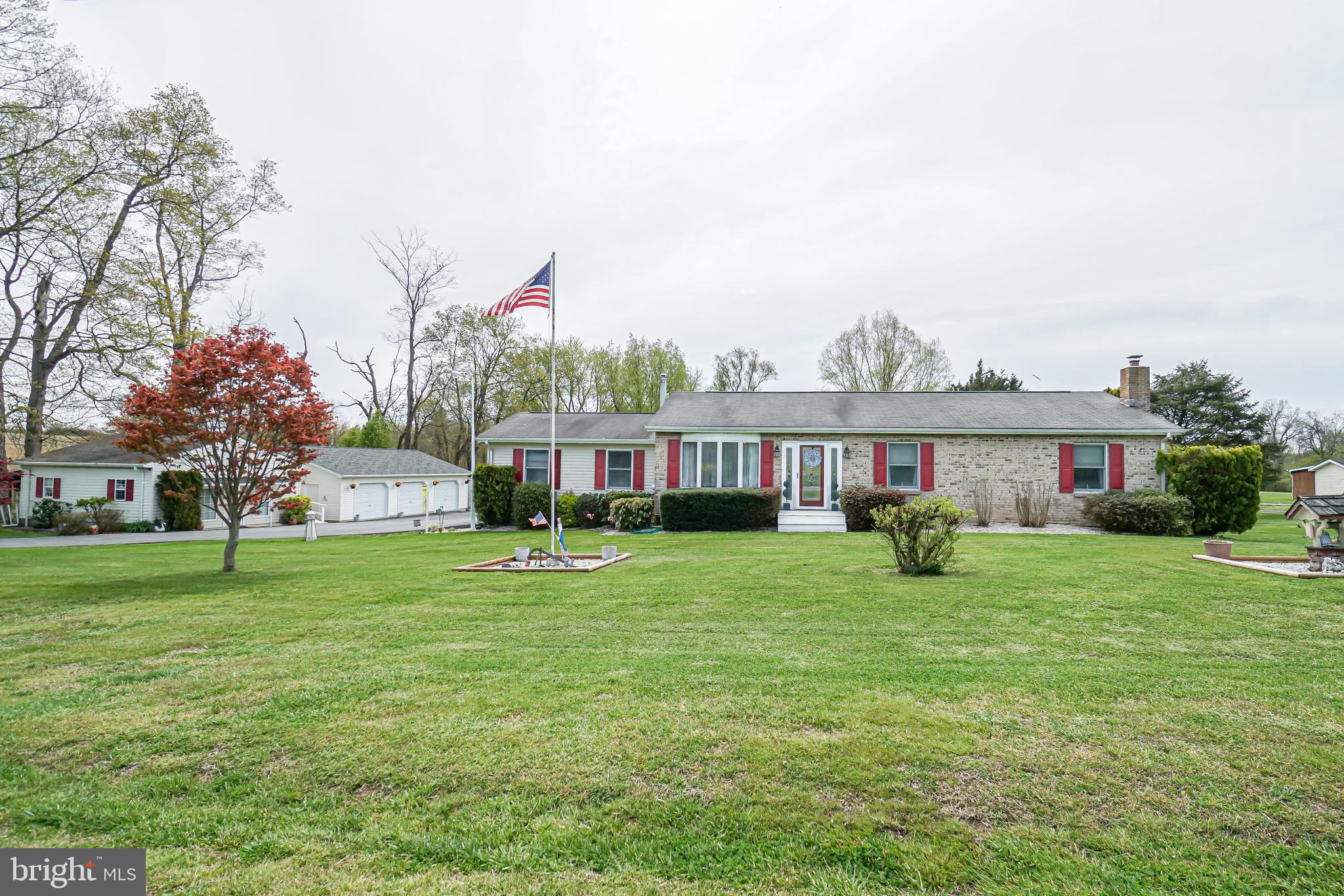 There is more than meets the eye in this spectacular rancher! Hardwood floors installed in living room and hall in 2015 as well as a new front door. The country kitchen has new white vinyl plank style flooring installed in 2020 and a kitchen island, cabinets, appliances and Corian style counter tops all installed in 2012. The sunroom had new vinyl plank laminate flooring installed in 2020, a vaulted ceiling and a pellet stove with doors that lead to the large, partially covered deck. New laminate floors installed in all three bedrooms in 2017 and an 11 x 14 master walk-in closet in 2019. Both bathrooms had new toilets, sinks and ceramic tile installed in 2017. Most plumbing was updated in 2010 and new heat/ac duct work installed in 2017. New ceramic tile installed in the entire lower level in 2017. The lower level family room has a wood stove and an abundance of closets and storage. Also in the lower level is an office, and hobby/storage room. Solar system (owned) and 75 gallon water heater installed in 2015. Security system with camera system is also owned. This home features a a 12 x 16 shed, a two car side load 20 x 22 attached garage, a detached 30 x 40 front load garage with electric, a 24 x 24 workshop with a propane heater (propane not provided) and electric (this workshop could be changed back into a front load garage by putting the garage door back on). With over 1.7 acres this lot features a koi pond, thornless blackberry bushes, an herb garden and a rose garden.Sellers are requiring all who enter the house to remove their shoes, wear face masks and wear gloves (seller will have some gloves on site). Please follow the COVID-19 CDC & MAR guidelines for showing.