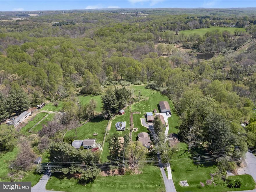 Incredible new price for this fantastic little Farmette! In Howard County and less than 2 minutes from the downtown historic district, it is conveniently located but a peaceful retreat.  The updated Cape has original hardwood flooring and two fireplaces.  On the main level, separate living and dining rooms flow into the huge country kitchen with stainless appliances and an inviting island with large table space in the breakfast room overlooking the backyard.  Two main level bedrooms share a full bath with two additional bedrooms upstairs currently connected.  The finished lower level has an updated full bath, family room with wood stove, game/exercise room, and an office/study area currently being used as a 5th bedroom.  Located on 1.25 acres with no HOA, possibilities for the property are great.  There are happy producing chickens, extensive gardens yielding notable vegetables, and even an orchard!  The fenced area with shed in the past had a horse and it is close to the state park riding areas.  An oversized, detached two garage has extra storage space and there is plenty of additional parking.  Marriottsville Ridge schools.  Some photos have been virtually staged