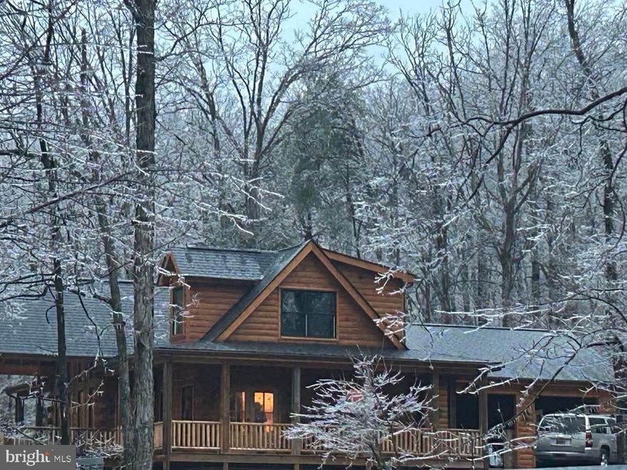 LARGE DETACHED GARAGE ADDED TO THIS LISTING 30 X 40 WITH 14' DOORS.  MORE PICTURES COMING THIS WEEKEND.  Nestled on 6 beautiful acres, this stunning log home crafted with classic D-logs the perfect blend of rustic charm and modern comfort.  Featuring 3 bedrooms and 3.5 baths, this spacious home is designed for both functionality and warmth.
The main level master suite is thoughtfully designed to be wheelchair accessible, providing convenience and ease of living.  Upstairs, you'll find two generously sized bedrooms,  with their own private bath-ideal for family members or guests.
The unfinished basement offers endless potential with lumber, doors, and trim already on site and ready to convey with the home - making it easy to customize and complete the space to suit your needs.  A few small projects remain, giving you the opportunity to add your personal touch and truly make this home your own.
Additional  features include a two bay attached garage and the house has beautiful decking and under cover porches that would make a great patio area for your enjoyment. Detached garage is included with this 6 acres. Enjoy the surrounding acreage, whether you envision gardening, recreation, or simply soaking in the peaceful country setting.
This property offers privacy, space and the timeless appeal of log home living-all waiting for your finishing touch.