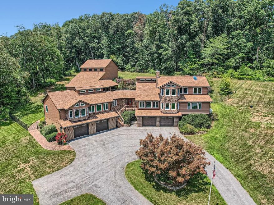 3 acres of Tranquil oasis featuring 5,250 sq ft of living space + 1800 sq foot of additional space in the Pool house & Gym.  The pool house features it's own full bath, covered patio, spectacular gym space while inside the residence features an additional 5 Bedrooms, 5 additional Full Baths (BA), 2 half BA, and a quarter bath in the garage.  The oversized 4 car attached garage features a ton of storage & provides access into the home.  This 30,000 gallon, heated pool will be sure to bring you joy from the waterfall element to accent lighting with app controls from your phone, & peace of mind with it's new pool filter & pool pump.  Enjoy your own hot tub, private putting green, 2 emergency generators, 2 x 1000 gallon, propane tanks which are owned.  The yard is accented with beautiful hardscape and stamped concrete around the home.  There are upgrades galore from a gourmet kitchen with spacious island, beverage station, tons of cabinet space with undermount lighting, and a gas hood.  The home also features 2 new roofs 1) on the home;  & 2) on the pool house (2023), 58 x new thermal windows for energy efficiency, + 2 new sliding doors off kitchen and bedroom.  There is a new low maintenance, Trex deck overlooking your outside oasis, new luxury vinyl plank (LVP) flooring throughout the inside main level and carries through walk way to lower level.  This home has many additional upgrades and special features including instant hot water, radon remediation system, convenient main level laundry, fireplace, vaulted ceilings, walk in closets, plenty of storage, home office space on lower level with it's own half bath.   Main level couple add a door and have private in-law suite.  The views are breathe taking from every window in the home & the exterior has been cleared of dozens of trees.  What ever you are dreaming, this one is sure to turn those dreams into a reality and deliver!  Welcome home.  Schedule an appt today 

*If you may like to add more interior space, the owners have fully designed plans, ready for submission to the county, for addition living space you may like to add, over the left side of the residence.  The plans are ready to go.  You simply have to walk them into the permitting office!