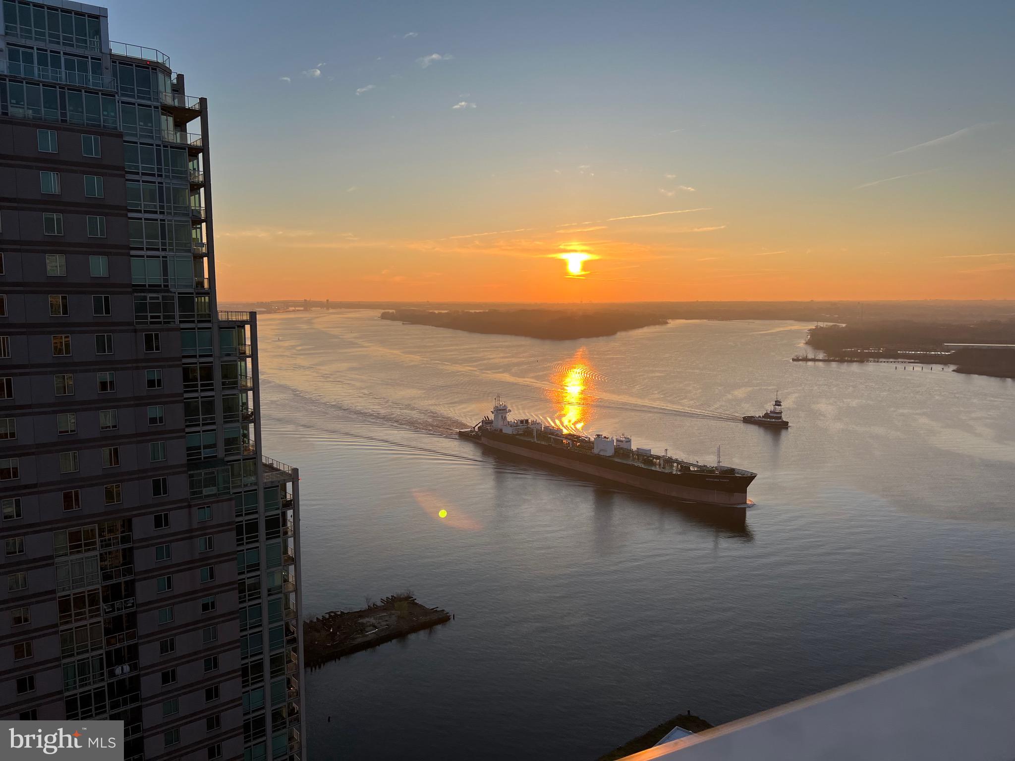 Enjoy amazing sunrises and panoramic views from of your own balcony from This rarely offered floor-plan. which overlooks the Delaware River landscape 24/7, 365 days a year! The functional floor-plan offers a unique space opposite the balcony, which can serve as an office or dining area. The washer/dryer is conveniently located in the island kitchen area. You can Enjoy partial views of Center City Philadelphia from
The balcony too! Waterfront Square Condominium & Spa is a premier gated community offering 24/7 guard and gate, as well as concierge, valet parking, pool and hot tub with river deck, fitness center, sauna and steam room, massage rooms and community rooms. There is a 3- level garage, with Philadelphia's largest green roof situated on top, inclusive of putting green! Waterfront Square resides on a 9.5-acre riverfront enclave, with lush manicured outdoor common parks and gardens right on the river's edge. Management is on site, and Waterfront boasts an advanced security system with closed-circuit television. For your convenience, Global Limousine runs on site from 6:45am to 7:11pm M-F, taking residents as far as 30th street and back home to their gated community. The river deck is oversized, encompassing a 25-meter heated lap pool (junior Olympic). Waterfront Square has an excellent location, due to it's proximity to area highways & airports (676,95, all bridges), yet is nestled away on the Delaware River - the best of both worlds! f its unequivocal luxury, showcasing the best views in Philadelphia, adorned with amenities, then it must be Waterfront Square Condominium & Spa!