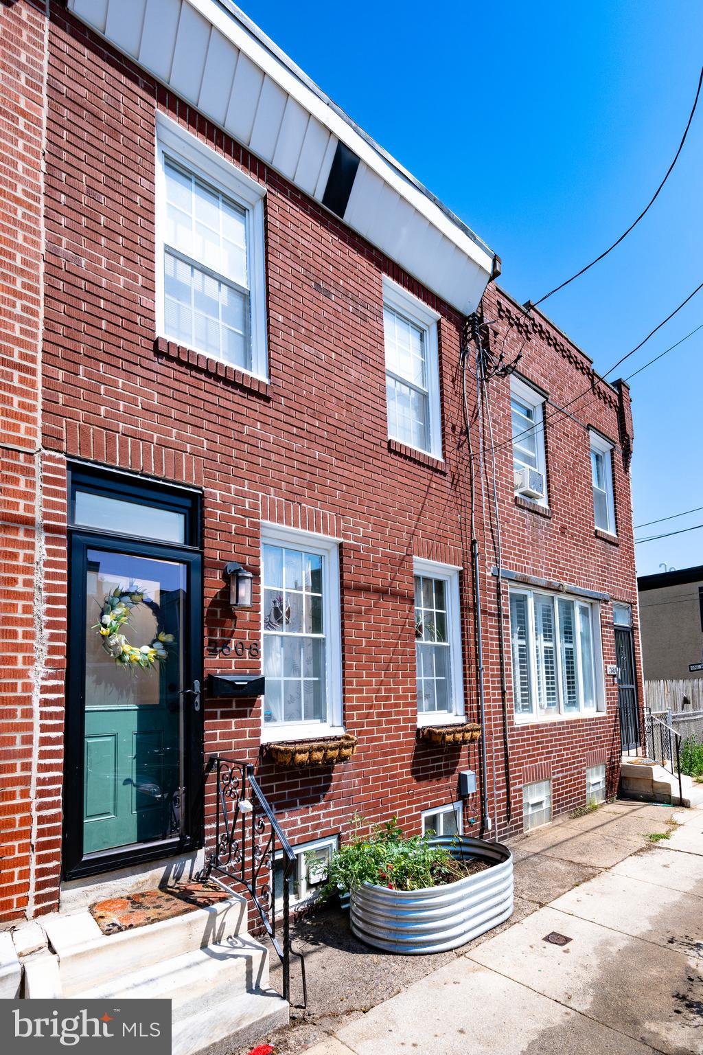 This brick front rowhome has hardwood floors throughout all of the living spaces, a sizable city yard and updates throughout. Flower boxes and a galvanized oversized planter greet you into this open layout family/dining room. There are new Pella doors on the back and front of this home. The living room easily fit the L shaped sofa, an oversized TV and an ample playroom. The kitchen features new white Quartz countertop, a Bosch dishwasher with a top third rack, a stainless double door fridge, garbage disposal, Moen faucet and wall shelving. The Shaker cabinets were just replaced, along with the Lifelock flooring and there is an under sink water filtration system. The rear patio awaits your summer BBQs. Upstairs, you'll find two generously sized bedrooms with closets. The front bedroom has a ceiling fan. The bathroom is very generous and might be a nice future location for a washer dryer or a gigantic linen cabinet. The basement is clean and dry and features the mechanicals as well as a washer and dryer with laundry sink. No need to wait for lower rates...this home is a rare opportunity to assume the owners' FHA 3.125% mortgage on this picture perfect starter home in Old Kensington, or it can be purchased with cash or financing of buyer's choice (but the rate would then be the same on this house as any other).