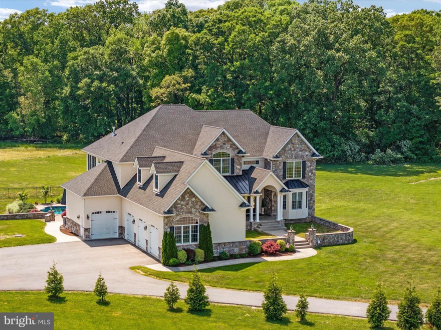 Welcome to a world of unparalleled elegance and distinction! Set amidst the tranquil beauty of Maryland's Eastern Shore, this custom-built sanctuary is a true masterpiece.  Crafted with meticulous attention to detail, every aspect of this home exudes sophistication and charm. Indulge in culinary delights in the gourmet kitchen, boasting dual islands, a Sub-Zero fridge, and a Wolf gas range with a pasta filler. The open floor plan flows seamlessly into the two-story great room, adorned with a majestic stone fireplace that mirrors the exterior stonework. Entertainment knows no bounds in the fully finished walk-out basement, featuring a theater room, wine cellar with custom wrought iron entry door, luxurious wet bar, and a versatile playroom/office/guest suite—all designed with your enjoyment in mind.

Step outside to discover a picturesque oasis on 3 acres (1.25 lot with 1.75 perpetual use easement) surrounded by protected farmland. Relax by the saltwater wet-edge abalone pool or unwind on the expansive Trex deck, soaking in the wooded vistas. Retreat to the primary suite, a sanctuary of tranquility and refinement. Tucked away from the bustle of daily life, this haven boasts a secluded sitting room, where you can unwind by the dual-sided fireplace and bask in the warm glow of the Juliet balcony. Prepare to be captivated by the pièce de résistance—the expansive closet! Designed with meticulous attention to detail, this walk-in closet features dedicated sections for both parties, ensuring ample space for all your wardrobe essentials. Located behind the primary closet is a bonus finished area, currently utilized as the perfect gym— could be the perfect craft area or home office. Indulge in the spa-inspired bathroom, where heated floors and a luxurious glass shower with body sprayers await. Every element of this suite is thoughtfully curated to provide the ultimate in comfort and luxury, elevating your everyday living experience to new heights. Guests will feel right at home as they cross the catwalk to the thoughtfully appointed guest rooms. Generous in size with a charming Jack & Jill suite and an inviting guest retreat with cathedral ceilings and a private bath.  Last but certainly not least, the Four-car side-loading garage configured for car lift (with poured footers), propane heat, and 17' ceilings with high lift garage openers:  Perfect for car enthusiasts, offering ample space and convenient access, a must-have for luxury living!
