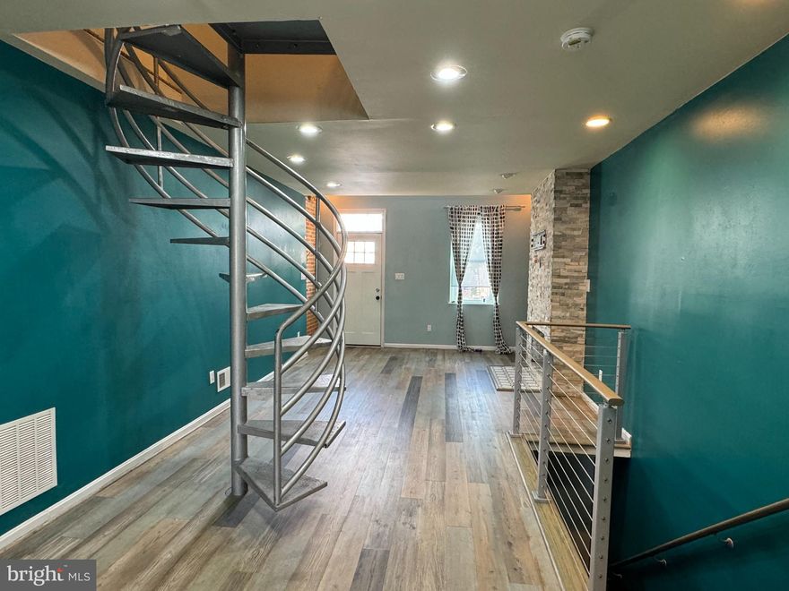 Washington Village living at its finest! Within walking distance of stadiums. Spacious living room, exposed brick, unique loft, hardwood floors, spiral staircase. Totally updated bathrooms, new flooring everywhere, and a renovated kitchen. Third floor master bedroom suite with fireplace, full bath, and access to rooftop deck. Partially finished basement, fenced-in yard with parking access