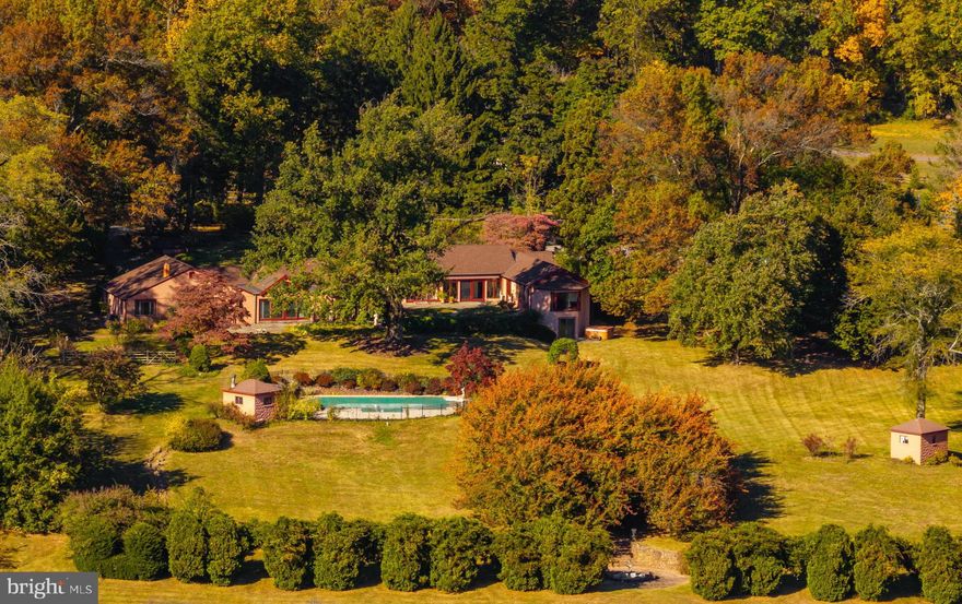 Welcome to 958 Catfish Lane, an exquisite property that exudes timeless elegance and sophistication. Boasting 5 bedrooms and 5 full with 2 half bathrooms, this residence offers an unparalleled living experience. Situated on a sprawling lot spanning 4.2 acres, this property epitomizes privacy and tranquility. 

Upon entering, you are greeted by an aura of refinement, with meticulous attention to detail evident in every corner. The grandeur, yet comfort, of this home is further enhanced by the breathtaking views out each window.  The layout was carefully designed to ensure seamless transitions between living, entertaining, and sleeping areas, while keeping openness and privacy at the forefront. The living area features a gourmet kitchen that opens directly into the vaulted family room with open sliding doors for indoor and outdoor entertaining. Off of the kitchen is a large butler’s pantry that leads into the magnificent dining room. The entertaining spaces include an expansive living room with exposed beams and gas fireplace, a library, and an enclosed sunroom that opens out to the large patio with electric awnings. The main level of the home also features a primary suite with stunning views of the garden, two en-suite bedrooms, and through the garage, a two bedroom with full bathroom guest suite, perfect for additional sleeping quarters or private office or studio. The walk-out lower level provides ample space for storage, and features a playroom, large recreation room, and living room that can also be used as another bedroom with en-suite bathroom.

Exiting the home from one of the many exterior doors, the allure of outdoor living is epitomized by the heated saltwater pool with jacuzzi, providing a haven for leisure and recreation. The meticulously landscaped gardens offer a serene escape, with lush greenery and vibrant blooms creating a picturesque backdrop for outdoor activities. As you explore the grounds you will find walking paths that lead you to fountains and different pockets of the lawn that will leave you in awe. The scenic beauty surrounding the property is simply breathtaking, with panoramic views that captivate the senses. 

This home presents an exceptional opportunity to indulge in life’s most important moments, with captivating outdoor spaces and a residence of distinction offering an unparalleled fusion of luxury, comfort, and natural beauty. Do not  miss this opportunity to make this once in a lifetime home your own!