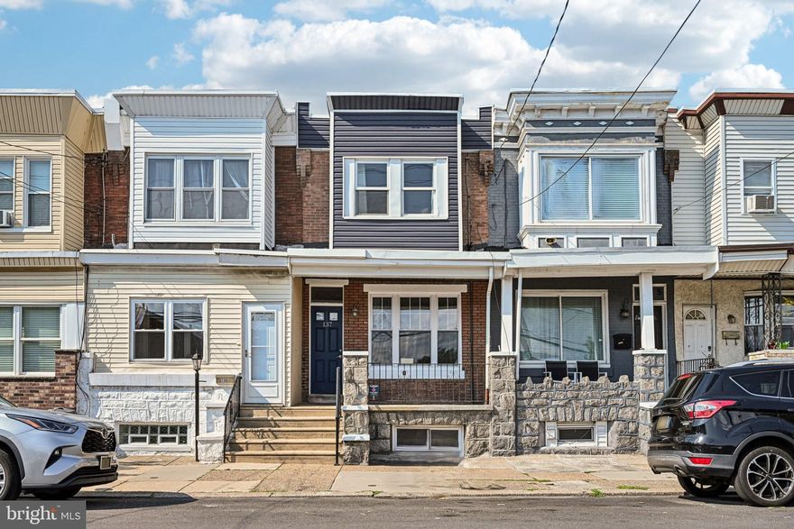 BACK ON THE MARKET due to buyer circumstances—not the home—this property offers aspiring homeowners a fantastic chance at a starter home. Welcome to this newly renovated rowhome in the desirable Whitman neighborhood! Enter from the covered front porch into a bright and airy open-concept floor plan, where abundant natural light, freshly painted walls, and gleaming hardwood floors set a warm and welcoming tone. The spacious living room flows seamlessly into the dining area and opens to a modern kitchen featuring stainless steel appliances, granite countertops, gas cooking, a stylish tile backsplash, and ample cabinet space—perfect for both everyday living and entertaining. A rear door off the kitchen leads to a private patio, ideal for summer BBQs or relaxing with a morning coffee. Upstairs, you’ll find three comfortable bedrooms with new vinyl flooring, including a generously sized front primary, all sharing an updated full hall bath with a tiled tub/shower combo. The fully finished basement adds valuable bonus space that can serve as a family room, home office, gym, or guest area, complete with a convenient half bath. A dedicated laundry room is also located on this level for added ease. The entire home has been thoughtfully updated throughout for a truly move-in ready experience. Don’t miss your chance to own this beautifully renovated home in one of South Philadelphia’s most vibrant communities—close to shopping, dining, parks, and public transit! Mortgage savings may be available for buyers of this listing.