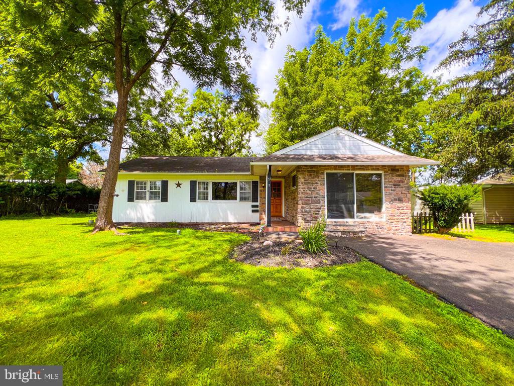 Fantastic opportunity to own a ranch home walking distance to Yardley Boro, the Yardley Train Station, and right across the street from Yardley Country Club. This 3 Bedroom, 2 full bath ranch home sits on a beautiful street and has a gorgeous, 360' deep wooded lot. Hardwood floors are throughout the majority of the home and there is real, rich wood paneling in the great-room. The great room also features exposed peg and beam details on the ceiling and a large picture window. The eat-in kitchen has lighter wood cabinets, stainless steel oven and refrigerator, replaced windows and recessed lights. The main bedroom has a pocket door, built ins, a large sliding glass door, and a remodeled en-suite bath with marble ceramic tile floors and surrounds, oversize vanity, and corner shower. 2nd full hall bath has ceramic tile floors and surrounds. Most rooms have deep baseboard molding. All 3 bedrooms have ceiling fans and ample closet space. Many of the windows have been replaced. The oil heater, central air and the hot water tank have all been replaced. Refrigerator, washer and dryer are included. The dining room could be a 4th BR, or den/study. The backyard is a wonderful park like setting with a deep wooded lot and 2 large storage sheds. The lot extends well into the trees in the rear yard. Low taxes for a single home in Lower Makefield/Yardley in Pennsbury schools. Great home with loads of potential is an estate sale and is being sold "as-is". This home is a short walk from the restaurants and shopping of historic and charming Yardley Boro and the Yardley Train Station. You're also minutes away from I-95, Route 1, the Princeton Corridor and other train stations with NYC destinations. Single home for the price of a townhome. This must see home can accommodate a quick settlement if desired.