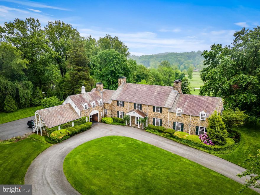 All stone 7 Bedroom, 5/1 Bath manor house. Gracious Foyer,  formal Living Room with fireplace, Family Room with fireplace and wet bar and formal banquet-size Dining Room.  The updated Kitchen features granite counters and a large breakfast area with French doors to the gardens. The expansive upper level is where the Primary Suite is found plus 6 additional Bedrooms, 4 Baths and a Bonus/Exercise Room. Stunning landscaping including old growth tress, sweeping lawns, beautiful gardens and a terrace with an in-ground pool and gorgeous vistas.