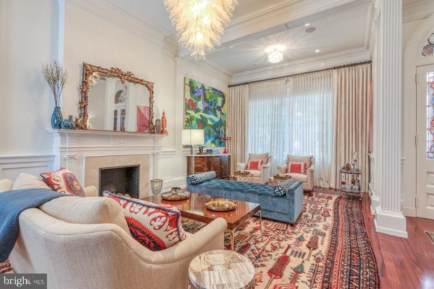 Welcome to 2032 Delancey Place - a stunning restoration in historic Rittenhouse Square that has everything you could want in a luxury home.  This distinctive home is complete with 5 bedrooms with ensuite bathrooms, 2 powder rooms, a 2-car garage, home gym, office, wine cellar, roof terrace & 5-stop elevator. The elegant facade with its ornate details and romantic bay window is only matched by the grandeur that awaits inside this 6000+ Sq Ft home. Enter into the vestibule with a mosaic tile floor and through the stained glass double doors which open into a stately living room with soaring 14' ceilings and a gas fireplace. Further down the hall is a powder room and fully equipped catering kitchen which includes a built-in refrigerator with freezer, dishwasher, sink, and motorized dumbwaiter with stops in the garage, basement pantry, catering kitchen, and main kitchen. A magnificent center staircase leads to the 2nd level of living which includes the open kitchen, dining room & family room. This gourmet kitchen is the ideal layout for any home-chef and features side-by-side Subzero refrigerators, a 6-burner commercial range with hood vent, additional wall oven, built-in microwave, marble countertops, custom cabinetry, and a walk-in pantry. The adjacent spacious family room is highlighted by a wall of south-facing windows and features a built-in home organization center plus access to an outdoor alcove with a built-in grill and cooking station. The formal dining room is just lovely with a fireplace flanked by built-ins and another wall of leaded glass windows. The 2nd-floor front Owner's Suite is a showstopper with a sensational bay window overlooking Delancey plus a fireplace, custom built-ins, an outfitted walk-in closet, plus 2 additional outfitted closets and a serene bathroom with radiant heated stone flooring, a freestanding soaking tub, a seamless glass shower, 2 marble vanities, and a separate toilet room. This room also includes a remote-controlled projection screen for optimal TV viewing. The 3rd level features 3 generous bedrooms with en-suite bathrooms, a laundry room, and a handsome den/home office with built-in shelving, gas fireplace, and wood-paneled walls. The 4th level, currently being used as a recreation room, is all open with lofted ceilings and a full bathroom. This level also includes a built-in wet bar with a refrigerator plus access to a breezy roof terrace with an outdoor TV and fire-pit for year-round enjoyment. The finished lower level was thoughtfully designed to include storage rooms, a pantry, plus a wine cellar and home fitness center. Other features of this home include 3 HVAC systems with 6 zones of heat & air, Brazilian cherry hardwood floors throughout, surround sound system, Tesla charging station in the garage, high ceilings on every floor, and an abundance of storage. An additional deeded parking space for a 3rd car is available and may be purchased separately. You will love this prime Rittenhouse Square location on a coveted residential street within blocks of the best restaurants, retail and parks that the city has to offer.  Virtual tour available upon request.