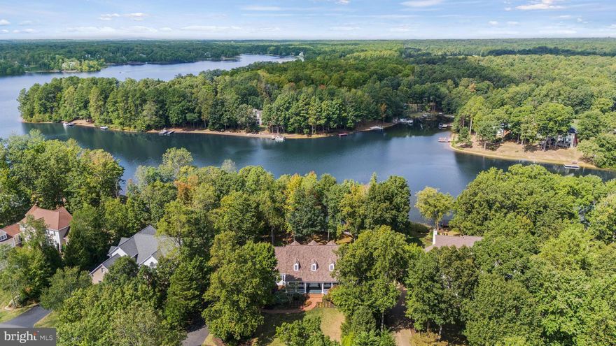 A RARE OPPORTUNITY TO OWN A LUXURIOUS  FAWN LAKE  WATERFRONT HOME !! This breathtaking, iconic, one-of-a-kind Cape Cod is a testament to timeless elegance and exquisite craftsmanship. As you step inside, you will be greeted by the grandeur of this meticulously designed home with stunning views of Fawn Lake that will not soon be forgotten! The main level features a spacious and inviting floor plan, perfect for entertaining guests or relaxing with family. The gourmet eat-in kitchen, complemented with a formal dining room, is an entertainer's dream featuring abundant storage and a bonus prep/catering kitchen designed to enhance your hosting and family meal planning experience. The great room with soaring ceilings perfectly blends comfort and sophistication while providing spectacular lake views. Enjoy more incredible lake views from the conservatory as you make your way to the  first floor owner's suite, boasting  cathedral ceilings, and providing  a serene retreat to unwind and relax.  Imagine waking up to the gentle sounds of nature and stepping outside to enjoy your morning coffee with uninterrupted views of tranquil Fawn Lake. As you ascend to the upper level, you will find four generously-sized bedrooms, two with their own Juliet balconies overlooking the lake.  One of the unique highlights of this home is the separate entrance to the upstairs office suite, offering privacy and convenience for those who work from home.  Start your day with panoramic views of the picturesque lake from your own personal workspace with a private bath and deck. The bright and sunny lower level of this home features walk-out French doors, wet bar area, recreation room, exercise room, additional bedroom and bath, outdoor shower, and plenty of storage for lake toys! Step outside to the idyllic, treed, lakefront oasis with brick patio. sandy beach, and lake-fed irrigation and take in spectacular Fawn Lake sunset views!  Stroll down to your private dock and swim, fish, or hop aboard your boat, kayak or paddleboard and explore 7 miles of  scenic shoreline! Don't miss the opportunity to make this remarkable property your own and experience the allure of lakefront living at its finest in Fawn Lake! The exclusive gated Fawn Lake luxury community offers amazing amenities such as a recreational lake with beach & marina, club house, fitness center, pickleball, tennis, basketball & volleyball courts, walking trails, soccer fields, restaurants, country club, golf course & so much more! Located near Fredericksburg, VA surrounded by protected parks and only a few miles to the farmers market, wineries & breweries!