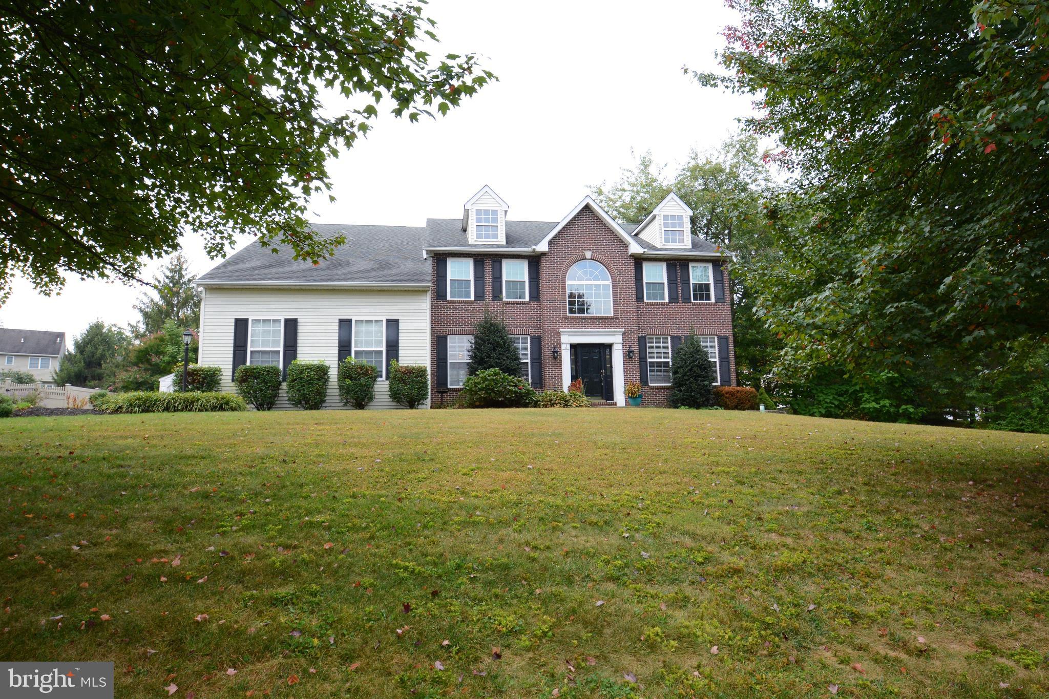 A beautiful, tree-lined street is what you’ll find as you drive up to this Sal Lapio–built colonial, offering 4 bedrooms, 2.5 baths, over 3,100 sq ft and timeless curb appeal with its classic brick front and mature landscaping. Located in Franconia Township in Souderton Area School District, this residence is close to major roadways including Routes 113, 309 and the new 309 Connector, as well as the Pa Turnpike.
Step inside the front entrance into a two-story foyer with a split staircase and hardwood floors that carry through the dining room, kitchen, and main hallway. The first floor provides plenty of space to live, work, and entertain with formal living and dining rooms, a private office, a cozy family room, laundry, and a convenient half bath. The kitchen is the heart of the home, featuring cream cabinetry, granite countertops, a massive kitchen island and breakfast area. A sliding door opens up to a two-tier wooden deck. This yard is perfect for nature lovers with a natural swale/wetlands off to the side.
Upstairs, new carpet throughout enhances comfort across four spacious bedrooms. The primary suite offers a walk-in closet with built-in shelving and a private bath with dual sinks, shower stall, and soaking tub. Three additional bedrooms share a full hall bath.
Additional highlights include interior access to the two-car garage, a full unfinished basement ready for your vision, and peace-of-mind upgrades including a newer roof (2013), water heater (2021), heating system (2015), and central air (2023).