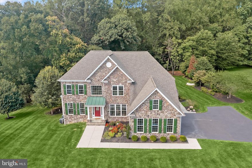 Exceptional custom home in the highly sought-after community of Castleberry at Ten Oaks, meticulously maintained by its original owners and freshly painted throughout. Tucked into a serene, private setting, this residence offers the perfect blend of elegance, comfort, and tranquility. A grand two-story foyer welcomes you with gleaming hardwood floors and an impressive sense of space. The formal living room features plush carpeting, crown molding, charming window seating, and a sun-filled bay window. The elegant dining room is designed for memorable gatherings, complete with hardwood flooring, crown molding, chair rail detailing, and refined lighting. The Chef-inspired kitchen is beautifully appointed with granite countertops, pendant and recessed lighting, gas cooking, a center island, a pantry, and a bright breakfast area with direct access to the expansive deck, ideal for outdoor entertaining. The adjacent family room invites relaxation with a striking stone-accented gas fireplace. A private home office with new plush carpeting provides the perfect work-from-home setting. A powder room and convenient arrival center complete the main level. Upstairs, the spacious primary suite offers a ceiling fan, a comfortable sitting area, and two walk-in closets. The luxurious en suite bath includes dual granite vanities, a soaking tub, an oversized shower, and a private water closet. Four additional generously sized bedrooms, including one with its own en suite bath, along with a full hall bath and laundry room, complete the upper level. The finished lower level expands the living space with a large recreation room, a sixth bedroom, a dual-entry bath, ample storage, and walkout access. Outdoor living is equally impressive with a custom fire pit patio and an expansive deck overlooking a private, tree-lined setting. A rare opportunity to own a beautifully maintained home that truly offers it all.