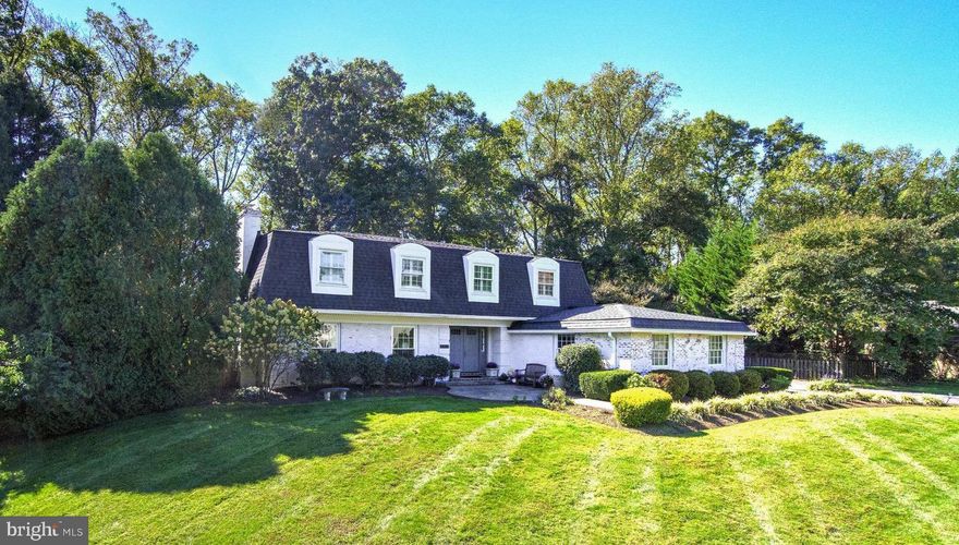 This special home in the idyllic Mclean neighborhood of Langley Oaks, offers an escape from the bustle of city life. Set on a half-acre lot with a classic French mansard roof and white-washed brick the home is surprisingly spacious with almost 5,000 square feet of living space that includes 6 bedrooms, 5 full baths and a 2-car side-load garage. The main level features a gracious foyer with a curved staircase and a large formal living room with woodburning fireplace, perfect for cozy evenings. A formal dining room sets the stage for entertaining, while the large, renovated, open kitchen is a chef's dream. Complete with Carrara marble counters, recessed lights and Viking and Jenn-air stainless-steel appliances, the kitchen is functional and stylish. A breakfast room and family room with built-in bookshelves and wood stove flow onto a patio overlooking a private backyard. The main level also includes a guest bedroom or home office and a fully renovated ensuite bath. Upstairs, discover a large primary suite with a tastefully updated bathroom and 3 more bedrooms sharing a renovated hall bath and a 5th ensuite bedroom. The lower level showcases a generously sized rec room and game room with built-in bookshelves, a craft room and a full bath with a steam shower. Nestled on a quiet cul-de-sac, this residence feeds into the Langley High School pyramid and offers easy access to Georgetown Pike and 1-495, making commuting a breeze. All this and just moments away from world-class shopping, dining, and entertainment at Tysons Corner!