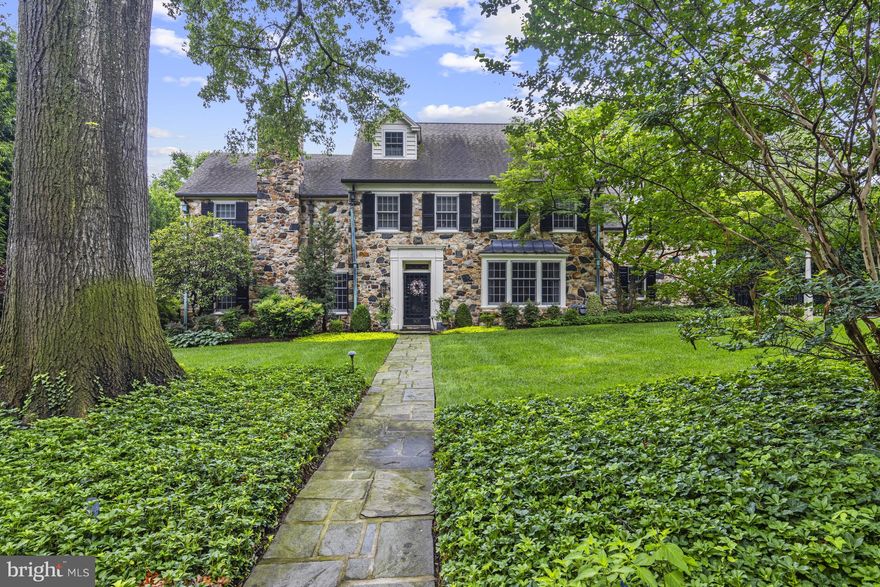 Dramatic and stunning, this stone colonial is located in Westover Hills, the historically significant neighborhood popular for its tree-lined streets and architecturally unique homes. Set on an over half acre lot with elaborate hardscaping and landscaping, this charming home has it all. Enter into the stately center hall foyer with powder room and immediately notice the charm and character unique to homes of this era, including a wide classic staircase with ornate newel post, gleaming wood floors and custom moldings. The foyer is flanked by a large formal living room with slate fireplace and a generously-sized dining room with large windows. The well-sized kitchen features island with seating, granite counters and stainless steel appliances. From the living room, head through either of 2 sets of French doors to find a versatile sitting/music room with built-in cabinetry. Continue through to an newer sunroom with flagstone flooring, picture windows and high ceiling. A comfortable family room with built-in shelving is tucked at the end of the foyer. Head up the grand main staircase and into the luxurious owner's suite with large bedroom, dressing area and updated en-suite with soaking tub, walk-in shower and dual vanity. A second bedroom has private bath and two additional bedrooms share a Jack-and-Jill bath. Continue to the 3rd floor to find an additional guest suite with an abundance of closet space, including a cedar closet. The partially finished lower level features a large game room as well as unfinished storage space and powder room. From the main floor sunroom, head out French doors through a portico to find the newly designed entertaining space which includes sprawling flagstone patios, built-in outdoor kitchen and covered breezeway from the 2-car garage to the main house mudroom. The detached garage features a large finished space above including kitchenette and full bath offering endless possibilities for apartment or private office. The fully fenced grounds are truly one-of-a-kind. Enjoy the classic features with all of the ease of modern living while being just steps from Downtown Wilmington, Trolley Square and Rockford Park with immediate access to Amtrak and I-95.