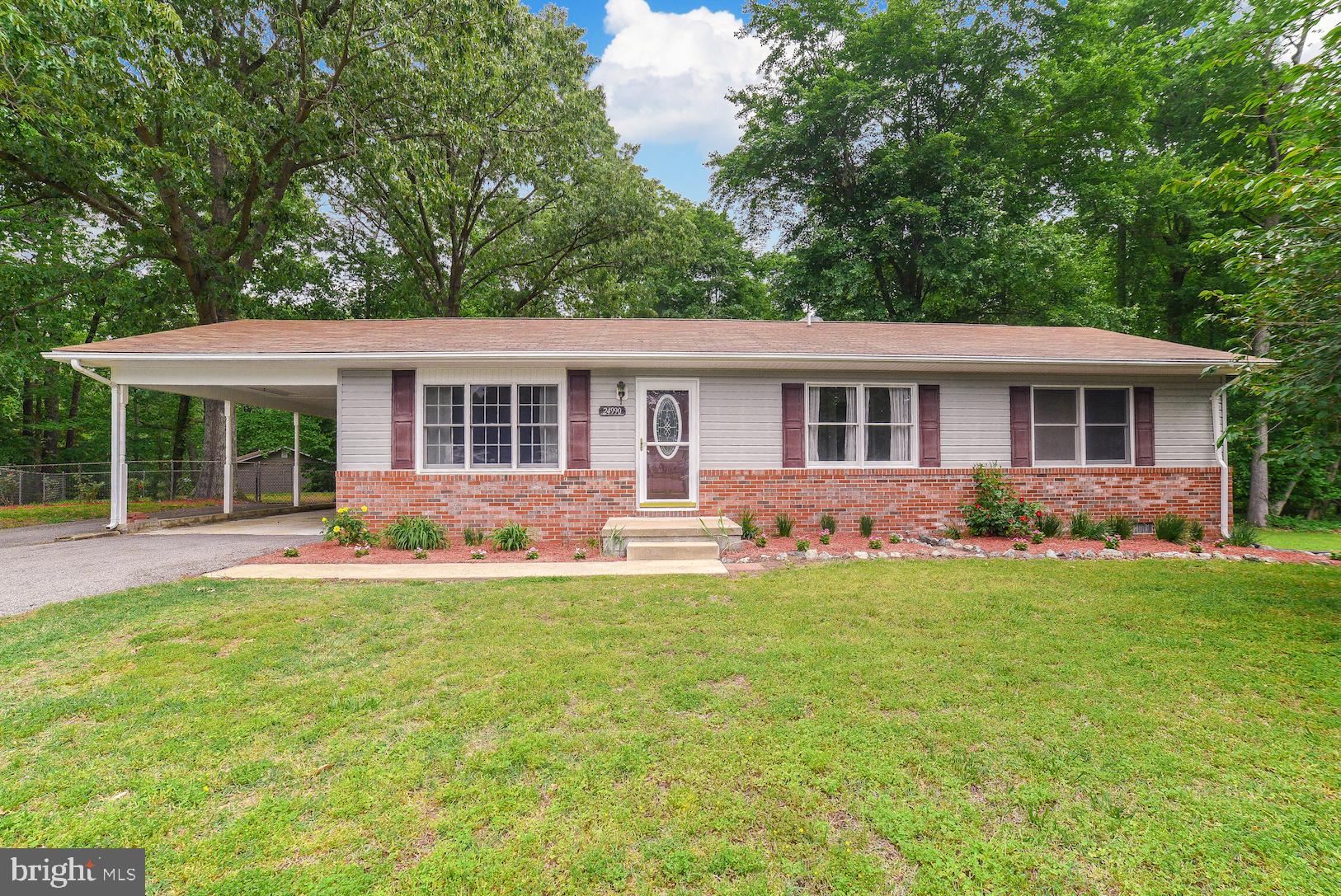 Welcome to this well-maintained home located in Hollywood. Three spacious bedrooms, freshly painted master bath with new flooring and an additional hall bath, two living areas, and an eat-in kitchen. The LARGE family/flex room has a custom bar (with speaker inserts) and wood stove that leads to the Amish-built deck. Updates through the years of current ownership include kitchen cabinets, counter tops, kitchen floor, living and hallway floor, deck, and HVAC. One-car carport, additional sheds and partially fenced corner lot that backs to trees. Minutes from shopping and NAS Pax River. No HOA!