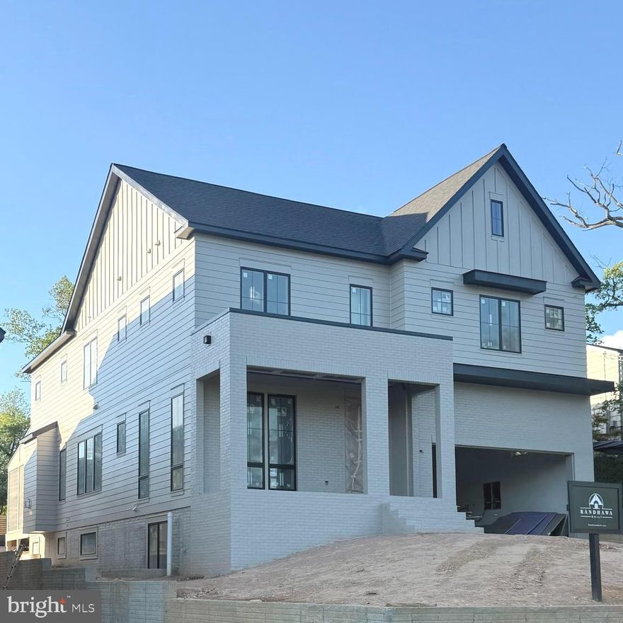 Scheduled for completion in June 2026, this exceptional new construction home by Randhawa Built offers the rare combination of sought-after McLean schools and the walkable lifestyle of Falls Church City. A highly regarded local builder with three decades of experience crafting custom homes in the Falls Church and McLean communities, their latest build is a 5-bedroom, 5.5-bath home with home office, screened porch, 2-car garage, ideally located with easy access to West Falls Church Metro, Founders Row, Birch & Broad, parks, playgrounds, restaurants, shops, movie theaters, High Point Pool, and the Washington & Old Dominion Trail (W&OD Trail).

Designed for daily living and effortless entertaining, the main level sets a high bar: 10-foot-plus ceilings, sand and stain red oak select flooring, custom millwork, and designer lighting throughout. At the center of the home, the chef’s kitchen showcases a Taj Mahal quartzite waterfall island with seating, a 60-inch Wolf gas range with pot filler, custom-integrated Wolf hood liner with 1,200 CFM blower, 48-inch French door Sub-Zero refrigerator with freezer drawer, and Cove dishwasher. A large pantry and smartly designed mudroom with direct garage access keep daily routines running smoothly. The breakfast eating area is next to the kitchen conveniently designed for daily use, with a separate formal dining room perfectly sized for entertaining.

The living area is anchored by a gas fireplace, with a full wall of glass doors opening to a screened deck overlooking a flat, private backyard. A wet bar with integrated glass rinser and custom fold-up pass-through window to the porch creates an exceptional indoor-outdoor entertaining experience.

The upper level consists of the primary suite overlooking the backyard, complete with integrated bedside lighting, a linear gas fireplace, massive dual customized walk-in closets, and a bathroom with separate vanities, oversized shower, and freestanding soaking tub. Each of the three secondary bedrooms includes its own ensuite bath and custom walk-in closet, thoughtful details that matter when the house is full.  A huge, light-filled laundry room with sink, quartz countertops, and built-in shelving completes the second floor.

Carefully planned grading and lower-level window locations allow for an abundance of natural light throughout the lower level. This level includes a private fifth bedroom and bath, a dedicated office or fitness room, open recreation and game areas, a second wet bar with quartzite waterfall counters and wine refrigerator, as well as generous storage throughout.

The exterior façade offers subtle hints of modern design while blending seamlessly with the surrounding neighborhood.  The front exterior feels grounded and well-balanced, with a substantial presence highlighted by a large covered brick patio, HardiePlank siding, and Andersen 400 Series windows.

A well-executed home by a designer and builder who has earned his reputation for quality, in one of Northern Virginia’s most desirable and convenient communities.