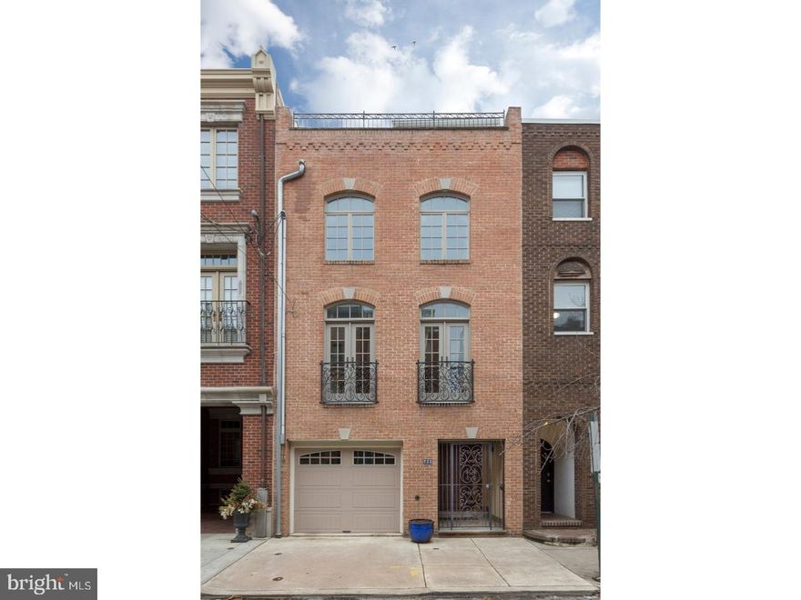 Rare opportunity to own an incredible, 8 year young, 3 bedroom, 2.2 bath home in Bella Vista, complete with three dens, two terraces, two Juliet balconies, 1-car garage and two years remaining on a tax abatement! This garage front home begins with a gated vestibule with tile floor and door leading into the garage. From the foyer, just 5 steps down, you'll find a fantastic family room/den/office with tall ceilings, hardwood floors, 2 windows, wet bar, powder room and double French doors out to a charming and private yard. The wide open living room, dining room and kitchen is located on the second floor and offers two Juliet balconies, a gas burning fireplace and spacious powder room. Enjoy prepping meals in the grand rear kitchen, dressed in granite, stainless steel and tile, and featuring a buffet cabinet with wine rack and cooler, a large bar counter, and French doors to a charming covered balcony. On the third floor you'll find two bedrooms with double closets, a den/office, a marble full bath with subway tile tub, a walk-in laundry room and a storage/mechanical room. The fourth floor begins with an open den, highlighted by built-in shelving, a dry bar and doors out to a rooftop deck with fantastic Center City skyline views. This level also hosts a bedroom with vaulted ceiling, triple window and gas burning fireplace, in addition to a 4 piece tile hallway bath with oversized stall shower, dual vanity with granite countertop and deep soaking tub. Make this house a home in beautiful Bella Vista, one of Philly's favorite neighborhoods, within the Meredith School Catchment, offering easy convenience to parks, shops, restaurants, the Italian Market, transportation and more.