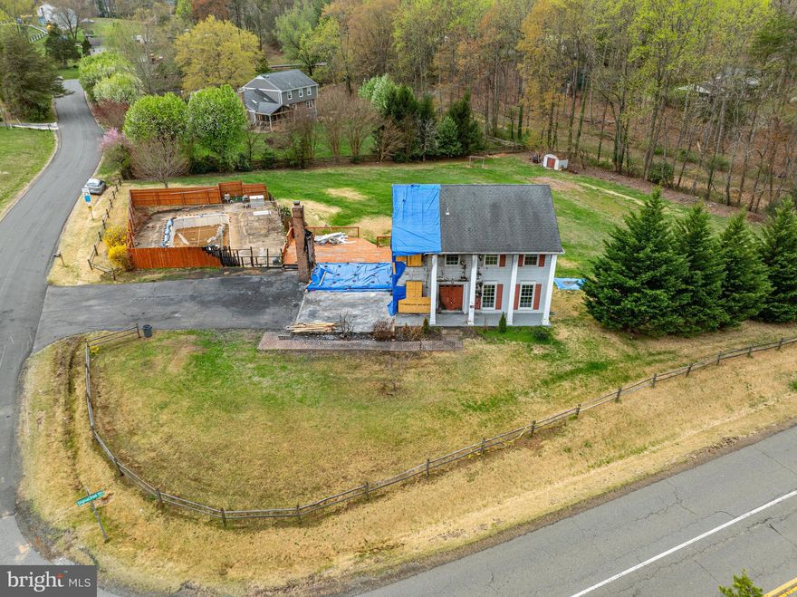 Bring your vision and creativity to this unique opportunity! Set on a spacious 1.30 corner acre lot, this property offers the rare combination of size, location, and versatility. While the existing home has experienced significant damage, it doesn’t require a full teardown – giving you the option to renovate or rebuild to suit your personal style. Whether you're an investor, a builder, or a homeowner this is your chance to design a custom home on a generous piece of land. The in-ground pool adds a great bonus, perfect for future outdoor entertaining or relaxing in your own private oasis. Tucked away in a peaceful, established neighborhood that offers rare privacy just minutes from shopping, dining, major commuter routes, and the VRE!