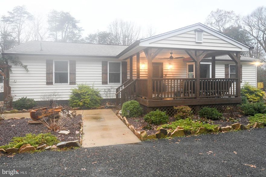 Custom-built rambler offering comfortable one-level living with a thoughtfully designed open floor plan and generous indoor and outdoor space. The spacious kitchen features granite countertops, ample cabinetry, and a pantry, opening seamlessly to the main living areas—ideal for everyday living and entertaining. Luxury vinyl plank flooring runs throughout most of the home, with carpeted bedrooms providing added comfort. Pocket doors are featured throughout, and new doors have been installed across the home, enhancing both function and style.

Enjoy peaceful outdoor living from the large covered front porch with ceiling fan or the expansive covered rear porch, both overlooking a private setting with approximately sixty acres of undeveloped land behind the property, ensuring long-term privacy and scenic views. Low-maintenance landscaping includes custom-ordered rose bushes that bloom in a beautiful array of colors. An efficient pellet stove provides supplemental heat, and a UV light filtration system is installed on the well for added peace of mind.

The property offers exceptional flexibility with a detached 28’ x 24’ garage equipped with a mini-split system, storage space, work table, and 150-amp electrical service, along with a secondary detached 16’ x 20’ garage. An RV or tiny-house site is already in place with two 50-amp hookups, one 30-amp hookup, sewer, and water connections—perfect for guests, hobbies, or additional living options. Plenty of space is available inside and out to park boats, RVs, trailers, and other recreational “toys.”

A digital television antenna is installed, with streaming and cable services also available. Conveniently located approximately six miles to Gate 3 at NAS Patuxent River, less than 10 minutes to NAS Patuxent River, St. Mary’s College of Maryland, and Historic St. Mary’s City, and about 15 minutes to Point Lookout State Park. Enjoy easy access to the Chesapeake Bay, Potomac River, and St. Mary’s River—all just minutes away—making this property an exceptional blend of comfort, privacy, and location.