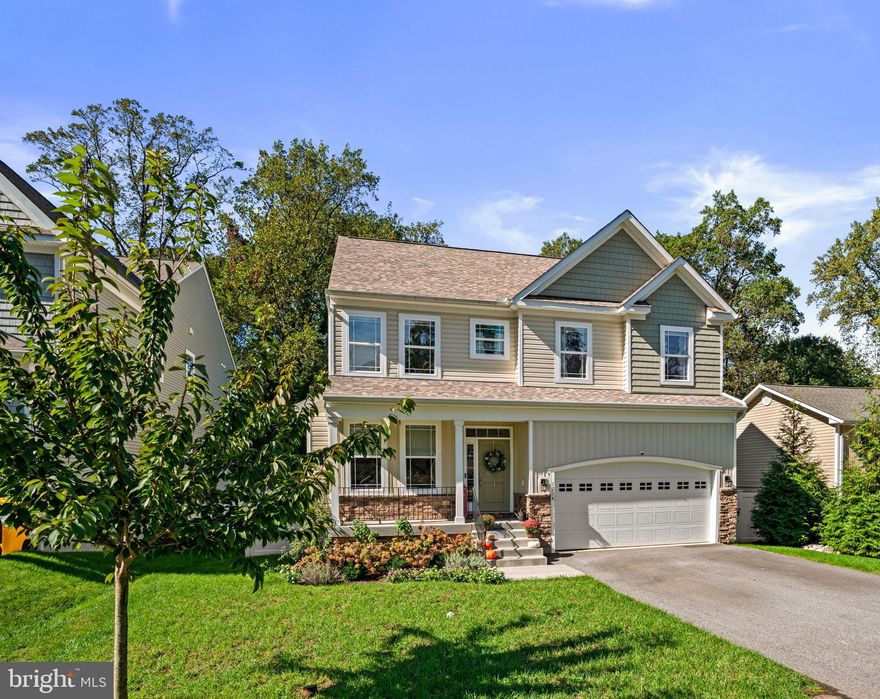 Welcome to this charming modern Craftsman-style home, offering 5 bedrooms and 3.5 bathrooms across three beautifully finished levels. Built in 2022, this home showcases timeless curb appeal and over 2,900 square feet of inviting living space filled with natural light. Step inside to an open and welcoming floor plan where the heart of the home is the stunning kitchen — featuring gorgeous countertops, a large center island, and stainless steel appliances. The kitchen opens to a cozy family room centered around a gas fireplace with a marble mantel, creating the perfect space for gatherings and relaxation. Upstairs, the spacious and airy primary suite offers abundant natural light, an ensuite bathroom with an oversized shower and soaking tub, and a generous walk-in closet. Three additional bedrooms, a full hall bathroom, and convenient upper-level laundry complete this floor, along with easy-access attic storage. The finished lower level expands your living and entertaining space with a large recreation room — ideal for a game room, home theater, or gym — plus a fifth bedroom, full bathroom, and walkout access to the backyard. A stylish bar area and additional storage complete this level. Outside, enjoy a serene retreat backing to trees. The deck invites you to unwind and take in the peaceful surroundings, complemented by a custom bluestone patio below, a fully fenced backyard, and all-new landscaping. Additional highlights include ADT security system, two-car garage, shed, and recently added gutter guards. Located in the Cape St. Claire community, residents enjoy easy access to the neighborhood playground, community beach, kayak racks, boat ramp, and clubhouse — bringing outdoor adventure and coastal charm right to your doorstep. All within the sought-after Broadneck school district and minutes from major commuter routes. Don’t miss the opportunity to make this home yours – schedule your private tour today!