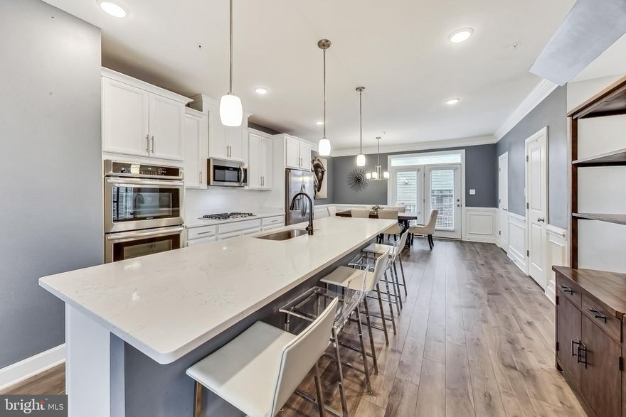 Welcome to one of the largest floor plans in the sought-after Riverdale Park Station neighborhood!  This exquisite End-Unit Townhouse features 5 Bedrooms,  2.5 bathrooms, 2-car garage w/ electric car charger, Private Patio, and Private Rooftop Deck overlooking this serene community. 

The home features an exceptional blend of luxurious living and contemporary design w/ an open floor plan design, 9ft+ ceilings, recessed light, crown molding, chair railing, hardwood floors and carpet throughout, lots of windows for natural light.  

The kitchen design offers sleek quartz countertops, high-end stainless steel appliances, gas cooktop, double oven,  elegant pendant lighting, and ample 42-inch cabinetry provide both style and substance for the avid home chef. The kitchen seamlessly integrates with the living and dining areas, forming a central hub for relaxation and socializing.  The upper floors offer spacious bedrooms filled w/ light and full-size front-loading washer and dryer.

The Riverdale  Park Station community is filled w/ shops, dining, parks, and entertainment options are all within easy reach, ensuring a lifestyle that is both convenient and enriching with immediate access to Whole Foods, Starbucks, Gold's Gym, and so much more.  Walking distance to the College Park metro and the MARC train stations and you will enjoy having the walking/bike path right outside fo your front door.  Don't miss an opportunity to assume a 2.25% FHA loan!