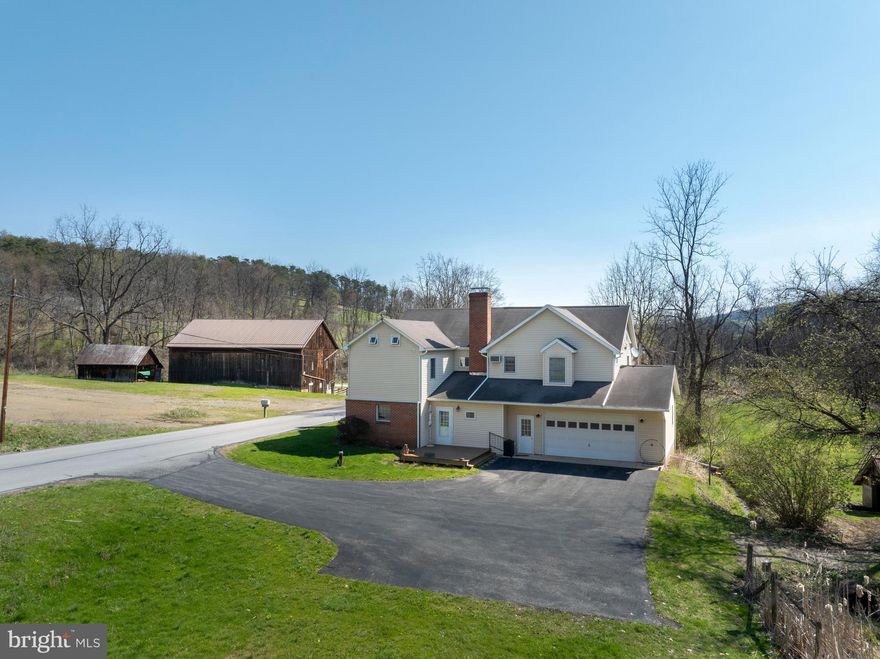 A rare opportunity to own expansive acreage with endless possibilities! Discover a truly unique rural property set on 113 picturesque acres in Alexandria, offering a beautiful mix of rolling hills, wooded areas, tillable fields, and an electric‑fenced pasture ideal for livestock or horses. Shavers Creek winds through the land, adding natural beauty and a peaceful place to explore for both recreation and agricultural use. The property includes a classic 2‑story farmhouse and a large 60x40 bank barn with water, electricity, a newer roof and floor beams, plus an equipment shed.

Originally built around 1890 and thoughtfully expanded over the years—including a 2006 addition—the farmhouse now offers 4 second‑floor bedrooms and 3 full baths, with the laundry conveniently located upstairs. The main level features a traditional layout with a cozy living room anchored by a stone wood‑burning fireplace, a charming eat‑in kitchen, and a formal dining room with a brick accent wall and mantle. Beautiful hardwood floors run from the foyer into the dining area. Enjoy the screened‑in front porch or the newly built composite deck overlooking the property. Additional highlights include an oversized 2‑car attached garage with workbench space, a whole‑house fan, a chlorinated water treatment system, and an unfinished basement ideal for storage or hobbies. This sprawling property is perfect for those who love the outdoors and want space to farm and enjoy the countryside. Schedule your tour today!

A one‑acre portion of the land is leased long‑term to a neighbor, and the fields are currently leased to a neighboring farm. See documents for more details.