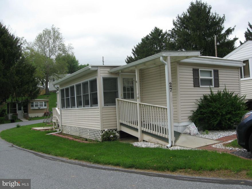 This older mobile home was renovated by a previous owner & the present owner has continued to make improvements.  One would never believe it is a 1967 mobile home.Roof replaced with a 20 yr. rubber roof. ceramic bath, kitchen island with ceramic top, hardwood floors, glass enclosed porch overlooking large pond. Park rent of $578 monthly includes water,sewer,taxes,2X week trash pickup& snow removal
