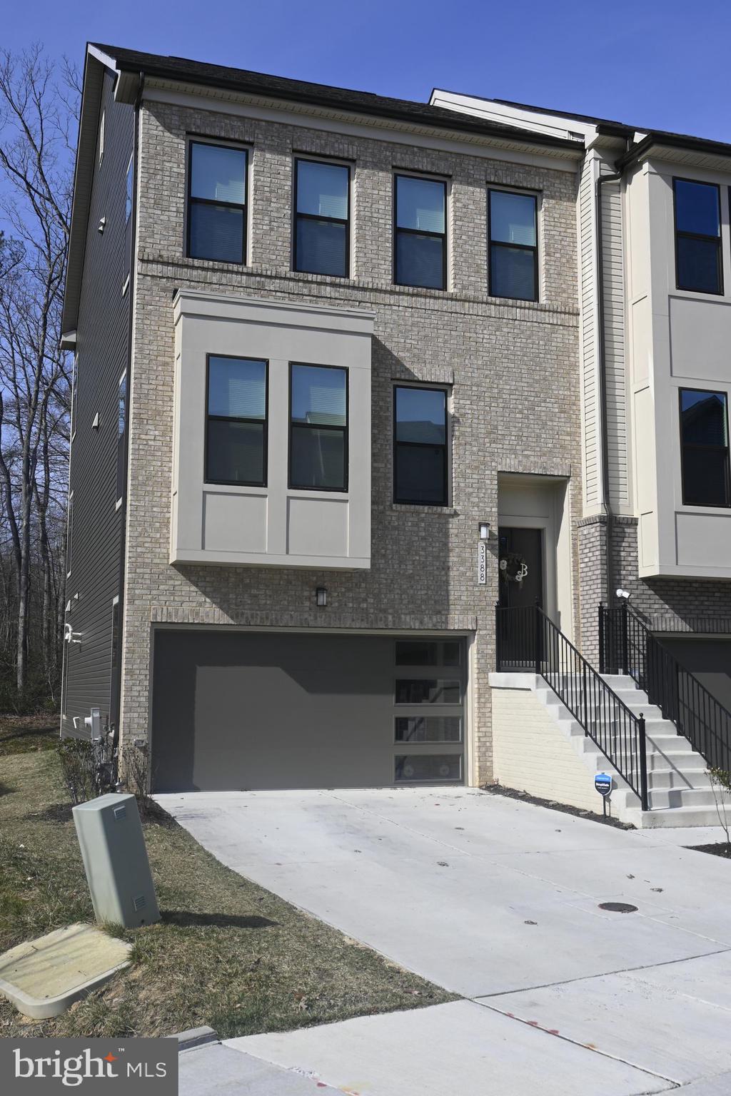 Welcome to Watershed!!! This community is conveniently located just minutes away from Fort Meade and approximately 30 minutes or less from Washington DC, Baltimore, Columbia, Annapolis and Arundel Mills. Watershed provides an array of amenities that include an outdoor swimming pool, gym, yoga studio, bike pump track, multi-purpose field, dog park, and playgrounds throughout the community. Commuters!!!! This property is only 5 miles from the Marc Train Station (Penn Line) that runs from Washington DC, through Baltimore, up to Perryville. This gorgeous end-unit townhome features a loft with a balcony on the 4th level, deck on the 2nd level, two car garage, gourmet kitchen with a range hood, oak wooden floors throughout the home and stairways. The kitchen features a level 5 Quartz countertop (color carrara breve). This kitchen countertop serves as an illustrious kitchen island providing extended seating with hanging pendulum lights. Additionally, the kitchen is equipped with whirlpool kitchen appliances, double bowl sink, and a huge pantry. Not to mention an electric heated fireplace mounted on a newly designed accent wall that matches the kitchen cabinets in the living space. The master suite has two huge walk-in closets, frameless shower with a beautiful newly installed backsplash, level 5 Quartz vanity, and a separate tub for your enjoyment. Additional features include brushed nickel handles on all the cabinets, privacy as it backs into woods, so that you can enjoy yourself while sitting on your back deck or the loft balcony. The second level and each bedroom provide top-down bottom-up blackout cellular shades. Additionally, the home is equipped with two wireless access points (WAP) to increase internet speeds throughout the house. This property is practically brand new and was acquired to include an extension to add extra living space. Note: Qualified VA applicants will have the option to assume the current VA loan at a 5.75% interest rate.