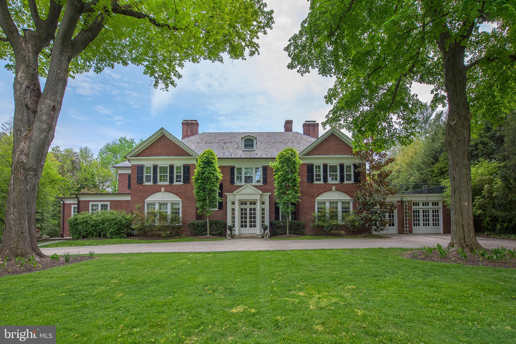 Welcome to this exceptional house in a premier location in historic Chestnut Hill. Built in 1922, this Seeburger & Rabenold designed brick Georgian is a standout among the residences created by this renowned architectural team. While the current owners have fully modernized the house, many original details were painstakingly preserved during the full house renovation in 2010. Significant updates were made with a commitment to maintaining the original intent of the house. This successful melding of old and new has created a truly special residence. The gracious front facade of matching gabled wings and pedimented portico with sweeping front lawn create a spectacular entrance to what is, essentially, a warm family home updated to accommodate today's lifestyles. The interiors are highlighted by detailed crown moldings, lovely wainscoting and significant millwork, large cased openings between rooms, high ceilings, and beautiful large windows which allow natural light to flood the spaces. The large entrance hall is fully open to the large and elegantly proportioned living room with its wall of windows, permitting expansive views of the flagstone terraces, gardens, and swimming pool. This stunning vista allows appreciation of the exceptionally spacious, private grounds which surround the home. The living room is flanked on one side by a sitting room with built-ins, a garden room with antique marble floors, and fully outfitted small greenhouse. On the other side of the living room there is a large formal dining room, kitchen, and family room. The eat-in chef's kitchen has been enlarged and fully customized, providing plenty of space for more intimate entertaining and casual day to day living. With an abundance of counter space, Wolf stove, 2 sinks, refrigerator and warming drawers, this sophisticated space with radiant heated floors is the heart of the home. An elegant staircase ascends to the second floor where a large space perfect for studying or watching tv creates a central gathering area. The master suite on the has a fireplace, extra large walk-in closet and his and hers baths, both with beautiful tilework and radiant heated floors. There are four more large bedrooms on this level, all with fully updated bathrooms. There is a third floor with bedroom, playroom, cedar closets, and abundant storage. Finally, the full basement is partially finished with wine storage for 1000+ bottles and a pool room with outside access. This one of a kind property presents a unique opportunity to live in a turn key, architecturally significant residence set in beautiful grounds in convenient, yet private, walk to town location with easy access to train, dining, shopping, and Center City Philadelphia.
