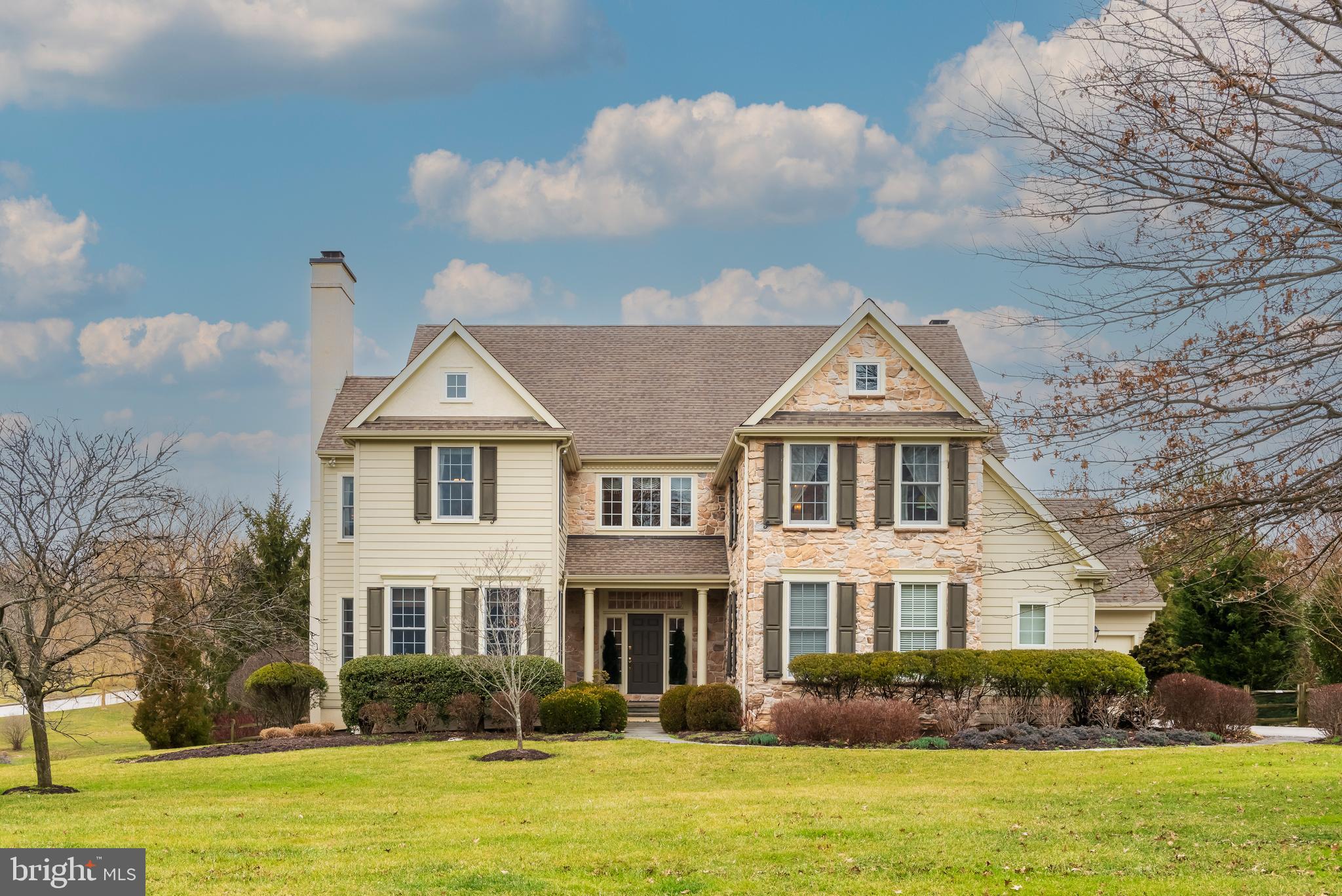 This stunning Ann Capron designed estate home expertly built and nestled in the highly desirable community of Fetters Mill. Featuring over 5,500 ft of gorgeous living space, including 5 bedrooms, 5.5 bathrooms, all within minutes of Rt 202, the PA Turnpike, the Malvern and Paoli train stations, and the Great Valley Corporate Center, and just a easy walk to Great Valley High School, the St Gobain campus trail, and the Chester Valley Trail.
The quality of this home is evident in the stone and Hardie Board siding, newer Anderson windows, architectural shingle roof. The residence boats 10ft ceilings, upgraded molding, coffered ceilings, wainscoting, tray ceilings, a whole-house sound system, gorgeous built-ins, home security system and so much more. Enter through the welcoming front door with transoms and sidelights into the grand 2-story Foyer with sweeping staircase. The stunning Kitchen features Sterling cabinetry, a gas cooktop, double ovens, and a large island. You’ll love enjoying meals in the bright Morning Room with wood shutters and outside access to the large deck. Relax in the warm Family Room with gas fireplace, impressive mantel, wall of windows and coffered ceiling. Entertaining in the elegant Dining Room with oversized windows and stunning wainscoting and the chic Living Room with fireplace will be a delight. You will love working from home in the bright Office with beautiful built-ins. Completing the main level are the Powder Room and Mud Room with lots of storage, a workstation and access to the 3 garage bays.
Upstairs you will find the Master Bedroom Suite complete with tray ceiling, Sitting Room, 2 walk-in Closets, and a luxurious Bathroom with jetted tub and large stall shower. There are 2 more Bedrooms, each with its own en-suite Bathroom and 2 more Bedrooms which share a jack and jill bathroom. Completing this level are a bonus Study Station and a Laundry Room. The fabulous lower level is as well finished as you would imagine considering the attention to detail in the rest of the house. Entertaining is a joy in the Kitchen with wine refrigerator, dishwasher, and microwave. There are also 2 full Media Rooms, a Billiards Room with built-in trophy case, a Gym, a Craft Room or second Office, and a full Bathroom. The outdoor living spaces are also outstanding. In a few short months you will enjoy grilling dinner and dining on the sizable deck with private views of the lush property. This amazing residence at 3 McCoy Court won’t last long!