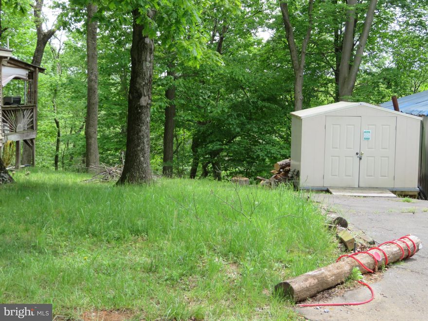 This lot is ready for YOU and your RV!!!
Nice level vacant lot tucked away in the back of Riverbend RV Park with a GREAT WATER VIEW!!!
Lot features water and electric hookups, shed, paved driveway, fire pit and Potomac River access for boating, fishing & swimming.  ** LOT BACKS TO TREES FOR ADDED PRIVACY **  Yearly membership to Riverbend Park includes water, sewer/pump out services, electric, trash and access to the park amenities and activities such as pools, putt putt, basketball court, tennis court, holiday fireworks for July 4th, car show, carnival, restaurant, playground, ball field and much more. Riverbend RV Park is located close to shopping, I-81 & The C&O Canal for hiking & biking. Own this getaway in as little as 3 weeks!  Call today before it's gone.  **Gated community-pass required for entry. **Riverbend sales are SOLD "AS IS", CASH only and seasonal.** (Direct TV and Frontier Internet available with service install/hookup).