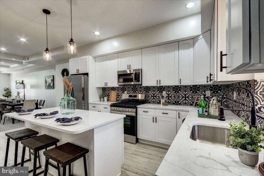 Step into this fully renovated row home, where classic charm meets modern elegance in a vibrant urban setting. Every inch of this exquisite property has been thoughtfully updated to offer a refined living experience, perfect for those seeking both style and convenience. As you enter, you are immediately welcomed by gleaming floors that reflect the natural light pouring in, complemented by new carpeting that adds warmth and comfort. The living space is accentuated by sophisticated coffered ceilings, creating an atmosphere of luxury and timeless style. The heart of the home is the kitchen, a masterpiece of design featuring granite countertops, a custom backsplash, and brand new stainless steel appliances, all set to inspire your culinary adventures. The master bathroom is a retreat in itself, boasting double vanities and custom tile work that combine functionality with high-end aesthetics. Here, morning routines are transformed into spa-like experiences, making every day a little more luxurious. Located just minutes from Johns Hopkins, downtown, and major highways, this home places you in the center of it all. Whether you’re a professional seeking proximity to the city’s core, or someone who enjoys the dynamic city life, this location ensures you’re never far from where you need to be. This property is more than a home; it’s a lifestyle choice for those who value beauty, comfort, and accessibility. Don’t miss the opportunity to own this stunning, turn-key row home in one of the city’s most sought-after neighborhoods.