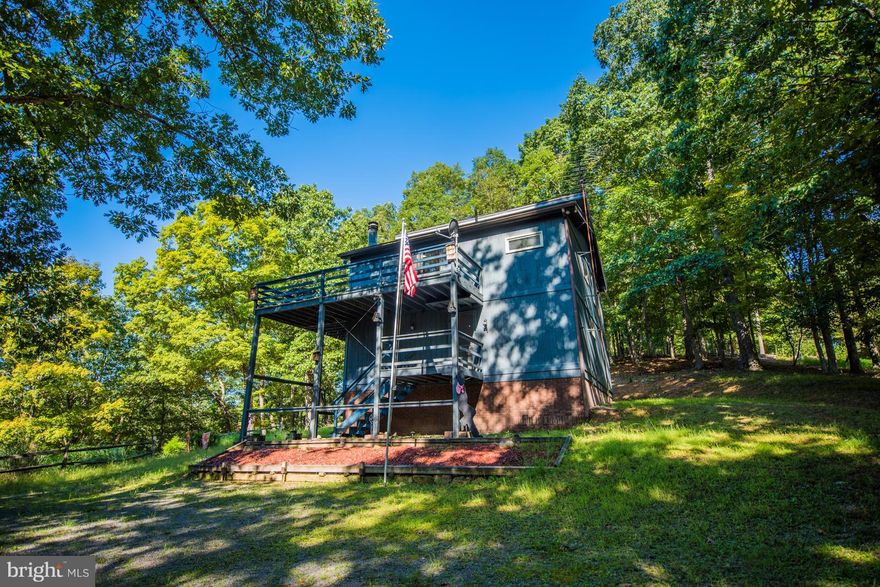 Enjoy the sounds of sights and sounds of nature from the deck of this lovely contemporary home in River Ridge, just 20 minutes to the historic town of Berkeley Springs, WV.  Waterfront on the Cacapon River, community river access and picnic area.  Three bedroom, 2 bath home with large great room, stone corner wood burning fireplace, and plenty of windows for natural light and to enjoy the views.