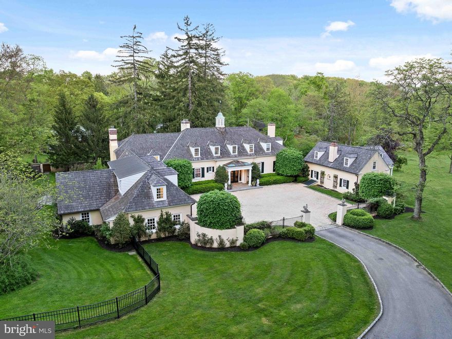 Nestled behind stucco walls on a lush 3.34-acre estate in prestigious Radnor Township ,  4 Welwyn Road is a historic carriage house transformed into a French-inspired architectural marvel. Originally built in 1920 and encompassing just under 6500 square feet, this property masterfully combines old-world charm with contemporary sophistication, offering a secluded retreat of privacy and luxury. As you arrive, the estate welcomes you with a striking gravel courtyard, setting the stage for its unique U-shaped design. This layout not only enhances the property's privacy but also strategically frames the beautiful courtyards, creating a stunning visual symmetry and providing multiple serene outdoor spaces, for relaxation and entertainment. Upon entering through the grand Foyer, the seamless flow between formal and informal spaces becomes apparent, facilitating both everyday comfort and sophisticated entertaining. The deep windowsills and gleaming random width floors throughout the home add layers of historic charm and rustic elegance. The chef’s Kitchen, equipped with top-tier appliances and bespoke cabinetry, is perfectly designed for culinary excellence and flows effortlessly into the formal Dining Room, Family Room  and the external courtyards, making it ideal for hosting gatherings of any scale. The First Floor also houses a magnificent Game Room, enveloped in rich wood paneling featuring custom corner cabinets that enhance its elegance. A custom bar and cozy fireplace create a warm, inviting atmosphere, making this room the perfect place for leisure and social activities.  On the Second Floor, the Primary Suite serves as a tranquil escape, featuring separate His and Her spa-like Bathrooms and providing a serene and private retreat away from the main living areas. Adjacent to the Primary Suite, a full Gym with the latest fitness technology and a state-of-the-art sauna offers a private wellness retreat, ensuring convenience and luxury are just steps away from the comfort of your bedroom. The Second Floor also extends the living space with three more Bedrooms and two full Baths, accommodating family and guests with comfort and privacy. The property also includes a separate Apartment in one wing with its own entrance, driveway, kitchen, two bedrooms, and an updated bathroom, offering privacy and convenience. Further enhancing the estate are a two-car attached Garage with an adjacent charming Potting Room, and secluded Pool set into a hillside and surrounded by mature landscaping offering a tranquil oasis. Nestled behind its protective stucco walls, 4 Welwyn Road is more than just a residence; it’s a sprawling sanctuary where history and modern luxury converge, making it one of Wayne’s most desirable hidden gems. Your dreams can come true on  THURSDAY MAY 9TH when all showings begin!!