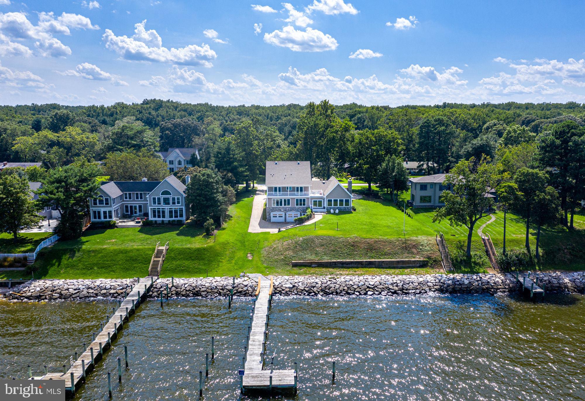 Drop-dead gorgeous views abound from this stunning waterfront location with 150 feet of frontage on the Chesapeake Bay. Sit back and watch the ships go by while enjoying the breathtaking sunrise. This turn-key 5 bedroom, 6.5 bathroom light-filled home was custom built in 2012 and sits on an expansive .91 acre flat triple lot with a circular paver-stone driveway and 3-car garage. With over 6,000 square feet of top-tier finishes and walls of glass, the endless Chesapeake Bay views are showcased on all 3 levels. This perfect waterfront oasis with an open floor plan includes a main-level master suite, shaded second-level patio, vaulted ceilings, library, sub-zero appliances, multiple en-suites, pellet stove, gas fireplace and media room. There are options for having a private pool built on this property and the private pier provides instant access to the Bay. The entire shoreline is protected by commercial-grade stone rip-rap. Podickory Point Yacht and Beach Club is right up the street where membership provides access to the pool, beach, deep water marina and waterside bar. This property is located in the Broadneck school district and it's the perfect location for quick access to hiking in Sandy Point State Park, heading over the Bay Bridge to the Eastern shore or jumping on Rt. 50 to get back to Washington, DC. 2035 Chesapeake Road offers a completely turn-key waterfront package with panoramic views of the Chesapeake Bay. Welcome home! To explore the property without leaving your home, be sure to view the Matterport virtual tour and the video tour.