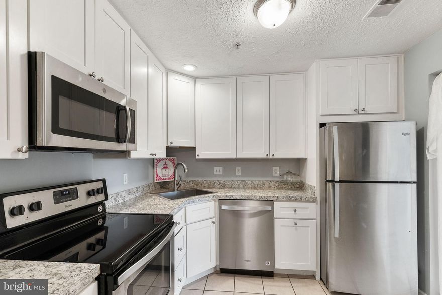 This bright terrace-level 2 Bedroom 2 Bath with 1173sf of space, in the Park View Community, is the perfect home or investment property. Cool marble-look vinyl flooring, newer stainless appliances, and newer full-sized washer and dryer mean you don’t have to do a thing except move-in. The updated dual-entry kitchen has an open pass-through window to the Living Room (not shown in photos) and is adjacent to the formal Dining Area for entertaining ease. The kitchen features newer stainless-steel appliances, bright white cabinets with soft-close doors, and tile flooring. The full wall of sliding glass doors opens out to the private patio and creates a light and airy Living Room.  This lovely condo is a corner unit, so the Primary Bedroom gets beautiful afternoon light streaming-in from windows on two walls.  The Primary Bedroom also features an ensuite bath and huge walk-in closet. The second bedroom has a large double sided closet and is adjacent to the hallway second Bath. You will love the newer full-sized front load washer & dryer in the separate laundry room., plus there’s an extra freezer that conveys. HVAC and appliances 2020.  The Unit comes with one assigned parking space and there’s plenty of guest parking. Park View Community is less than a mile to shops and just minutes to commuter routes. This is one of the loveliest Condos in Winchester!