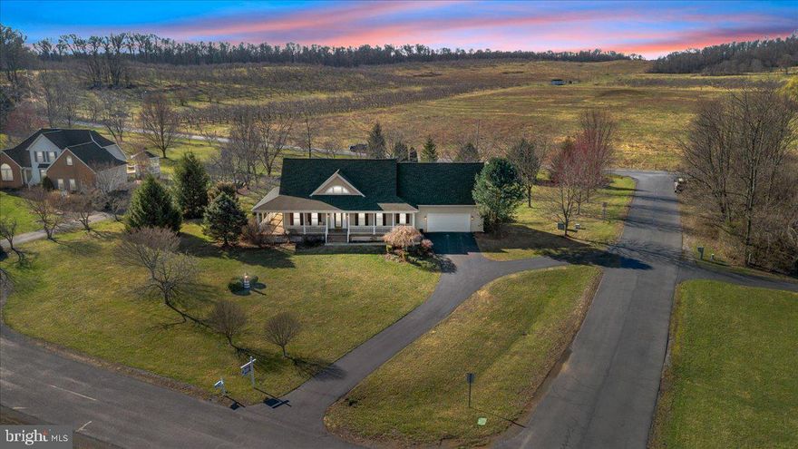 This beautiful 4 bedroom, 3 and 1/2 bedroom cape cod style home is nestled on an expansive 1.19 acre lot in a community surrounded by orchards and farmland. Not only are you on a corner lot, but it's on a quiet cul-de-sac street as well. The property exudes curb appeal. You have a huge, wrap around porch with solid mahogany decking and stunning mountain views. Inside there is a bright foyer with hardwood floors and crown moldings. To the right, you have an elegant dining room. This space features hardwood floors, crown and chair rail molding and a unique chandelier. The dining room is conveniently located adjacent to the kitchen. The kitchen features raised panel cabinetry and stainless-steel appliances. The peninsula island features breakfast bar seating for two. The space also features a built-in desk. There is convenient laundry room adjacent to the kitchen, featuring tiled floors, shelving and a utility sink. Beyond the kitchen is the bright breakfast nook, perfect for daily meals. Breakfast nook opens to the spacious living room. Here you'll find dual ceiling fans for comfort year-round, and a gas fireplace to make it cozy on chilly nights. Glass-paned French doors lead out to the large rear deck. Stairs lead to the 2nd floor hall. There is a convenient half bath on the main level for guest use. The cherry on top of the main level is the large primary suite. Your suite features hardwood floors, large windows, and crown molding. The ceiling fan light fixture keeps the space airy and bright. Your private ensuite bath features tiled floors and an extended double bowl vanity for tons of storage. You will have a walk-in shower for those busy mornings and a jetted soaking tub for relaxing evenings. The ensuite provides access to your walk-in closet with built-in shelving. This is a comfortable, main level oasis. Upstairs you have a large walk-in hall closet with built-in shelving. This is amazing for storage. Bedroom 2 features carpet and a huge walk-in closet. It shares a Jack and Jill bathroom with Bedroom 3. The bathroom features two extended single bowl vanities, great for sharing the space. The bathroom also includes a beautiful, arch-top window, a separated water closet w/acrylic tub/shower and a large linen closet for even more storage. Bedroom 4 is a large junior suite. It has carpet, overhead lighting, large windows and a private ensuite. The ensuite bathroom features an extended single bowl vanity, tub/shower and a large linen closet. It also includes a private staircase to the main level. This could be great for guests or multigenerational living. The lower level of the home is already framed and ready to finish, with "Superior" exterior foundation walls that are predrilled for wiring and ready to insulate and drywall. Presently it works well as a home gym, rec room, and storage space. A slider and stairs lead out to your rear yard. Outside you have an expansive deck to host Summer BBQs, and a huge concrete patio that doubles your outdoor living space. Beyond the patio you have a large, lush, level lot. There's plenty of room and roam and space to enjoy. This property has everything you need, want, and then some. Don't let it get away - schedule your showing today!